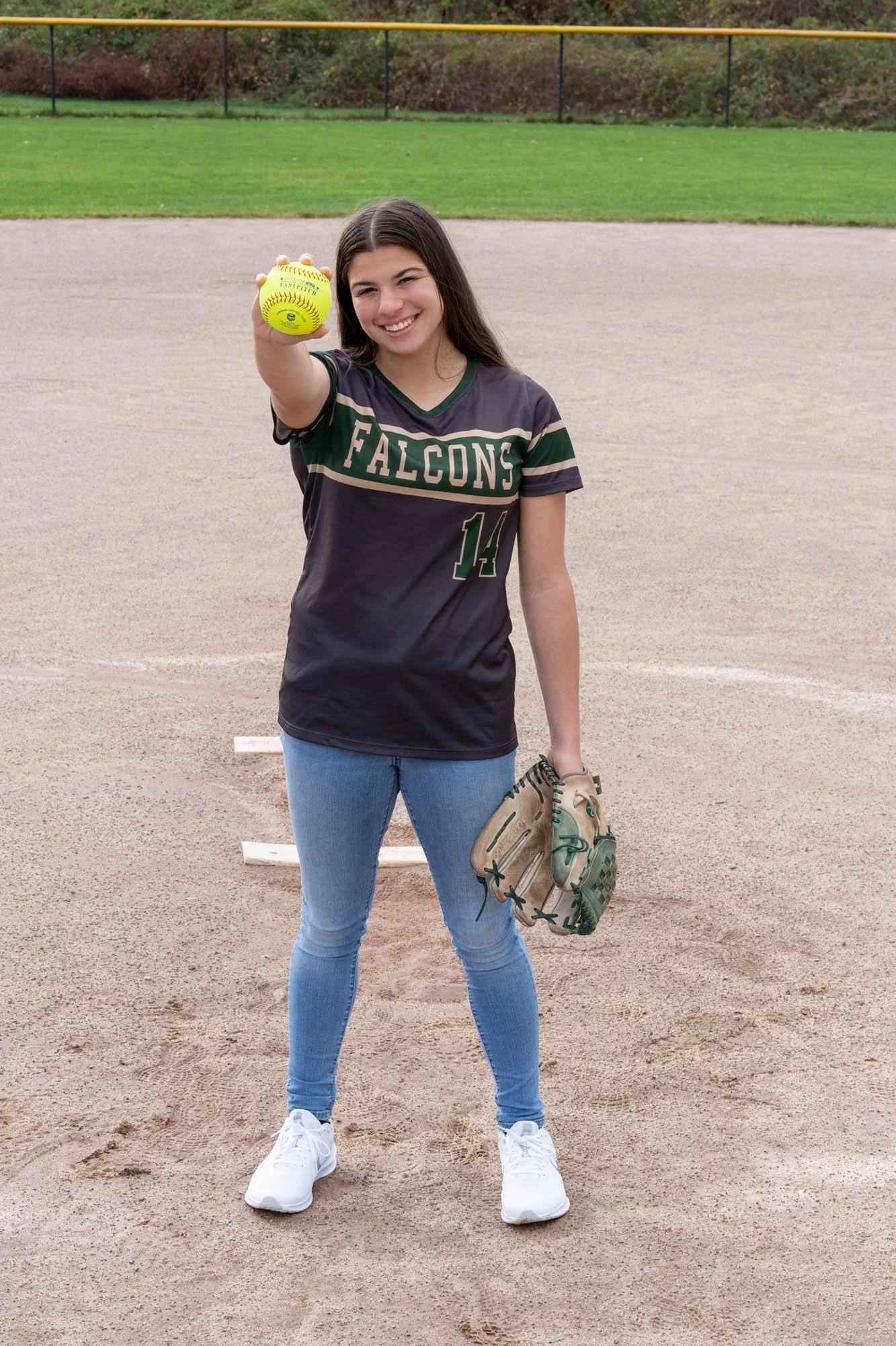 high school senior female softball pitcher with Falcons shirt