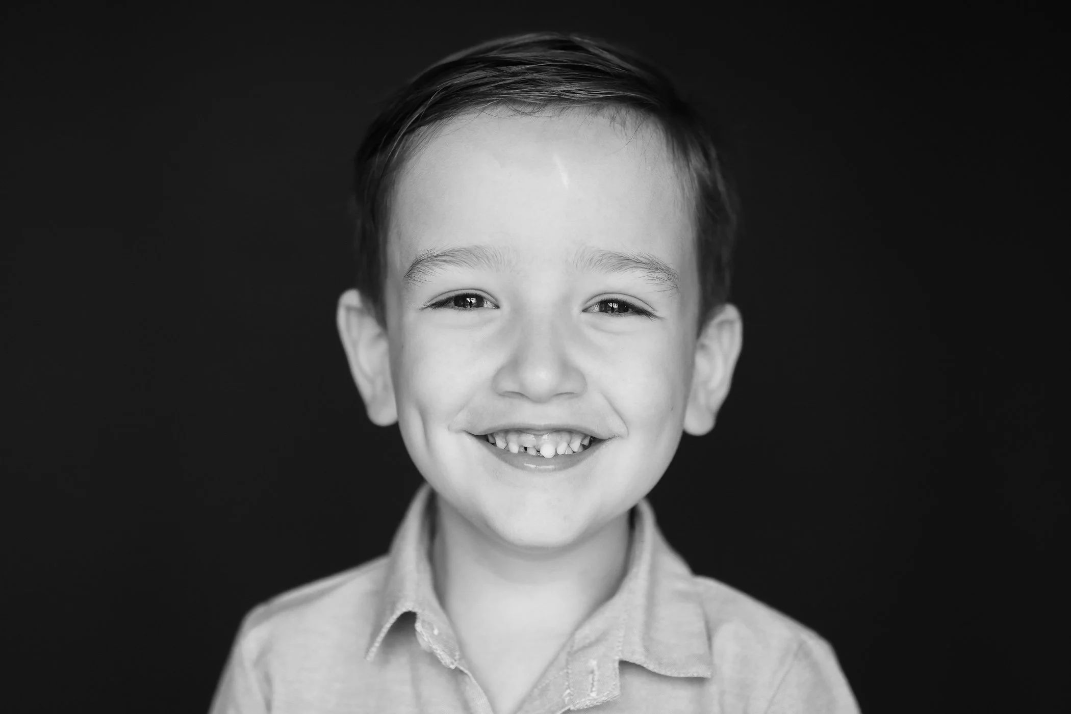 Smiling young boy with missing front tooth