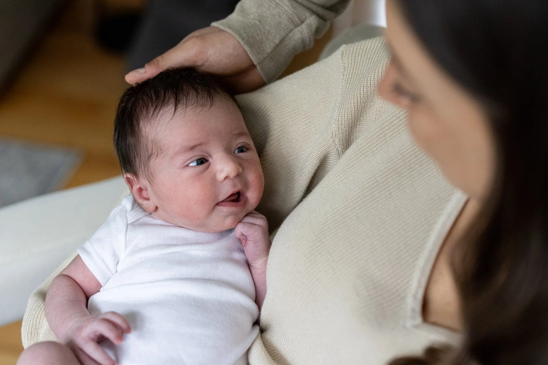 South Shore newborn photographer captures infant looking at mother