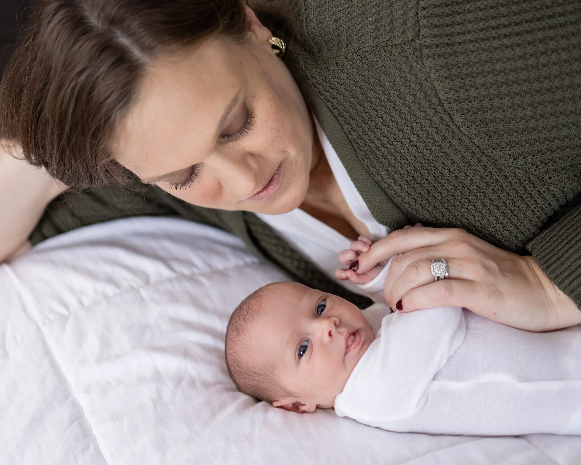 mom gazing at newborn daughter showing love.jpg