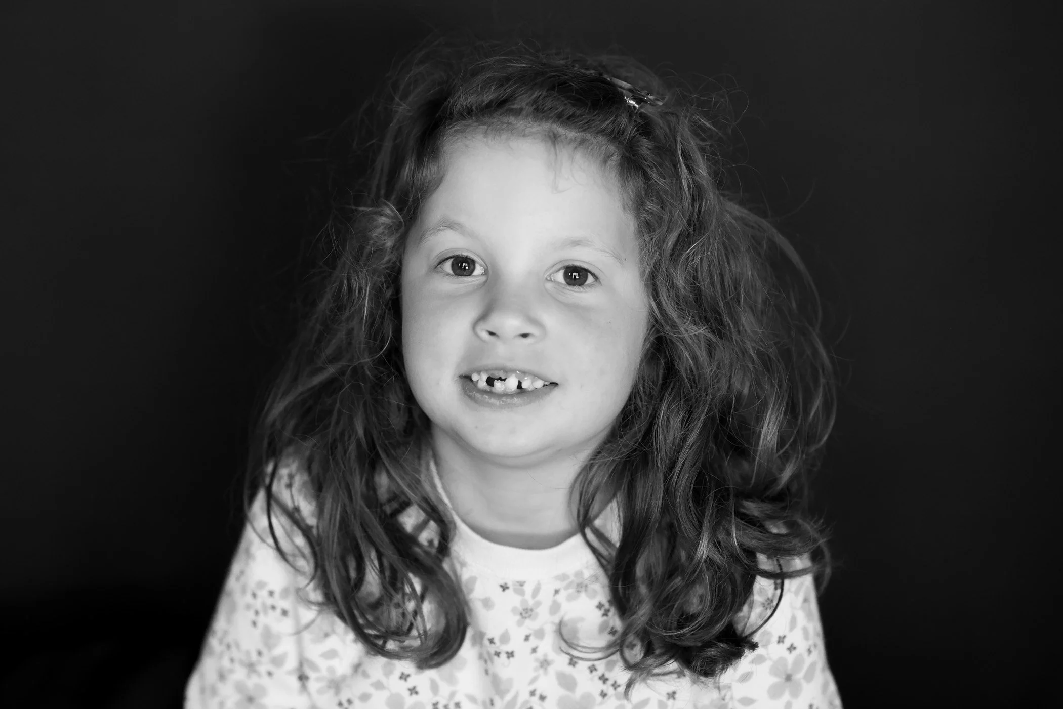 black and white of little girl wearing top with small flowers
