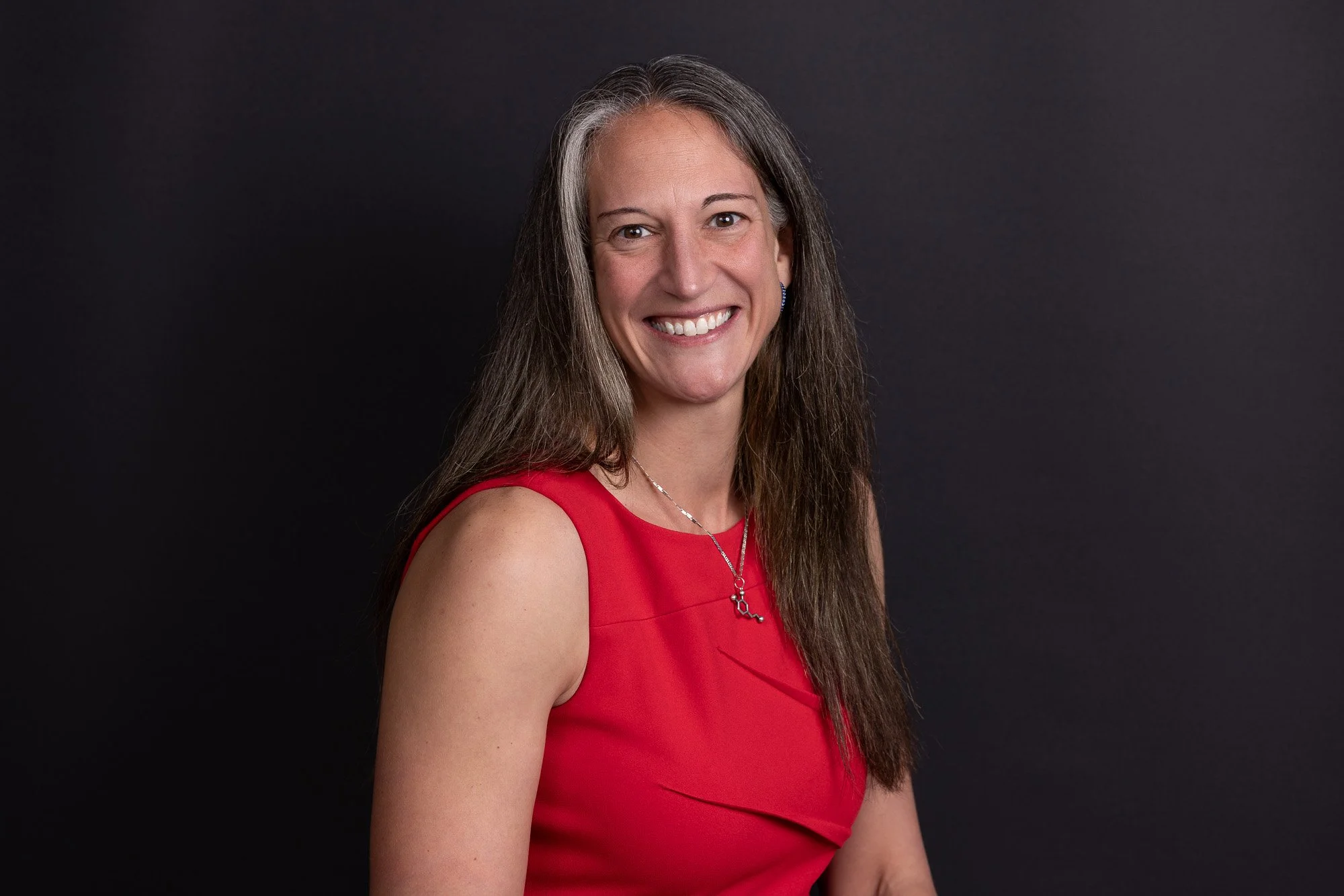 professional business headshot of woman wearing red dress.jpg