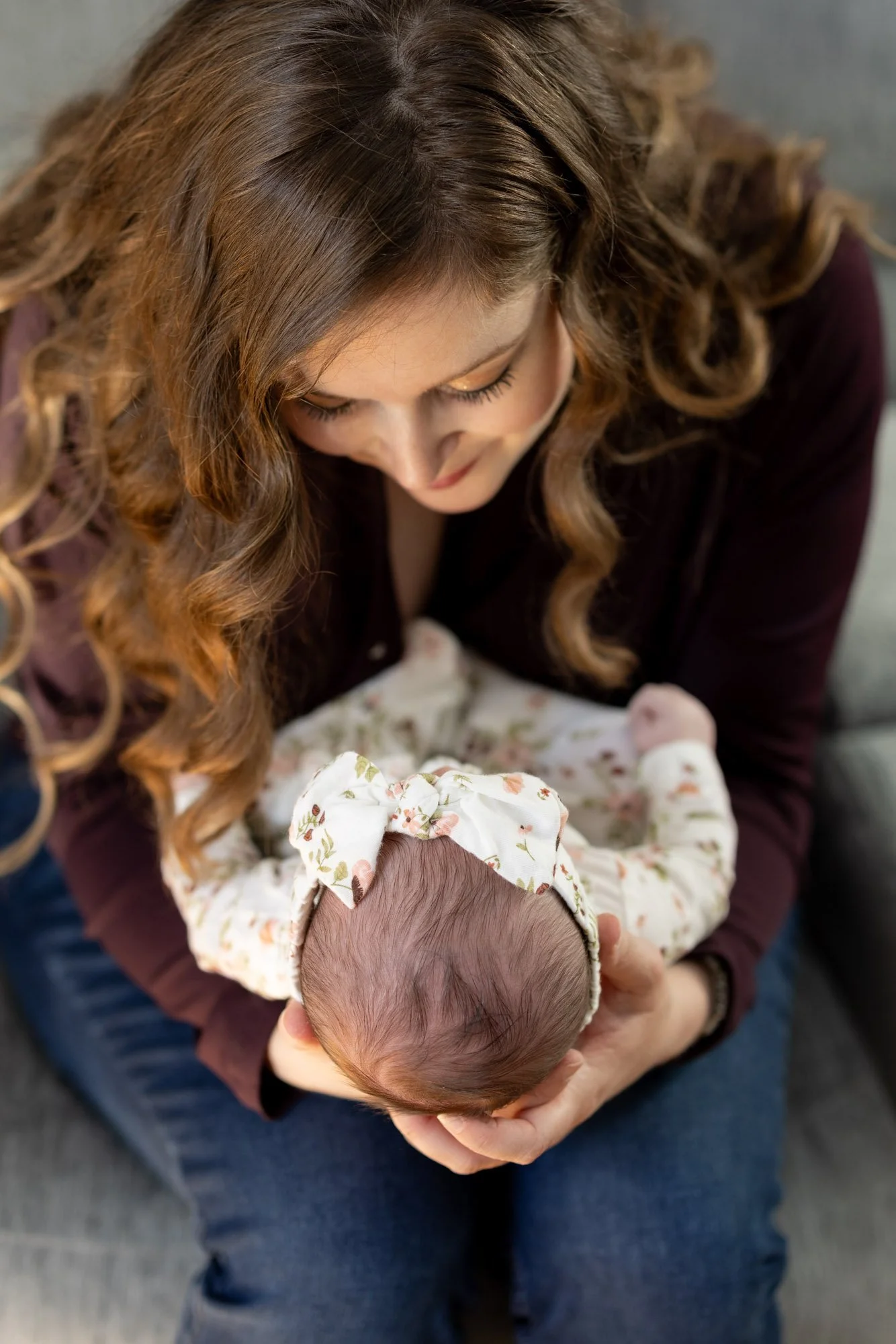 mom holding and staring at newborn baby girl.jpg