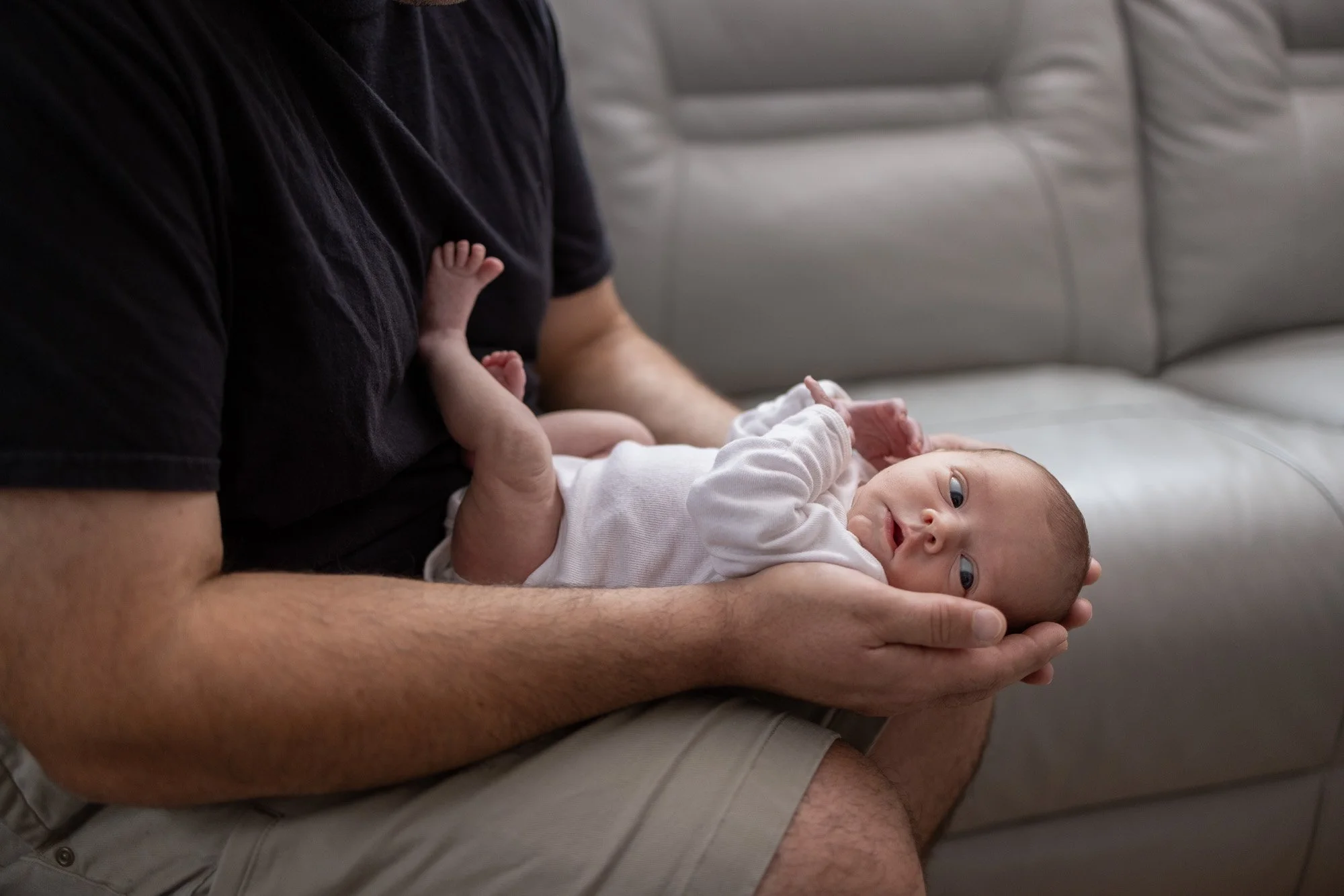 father holding newborn girl on lap.jpg