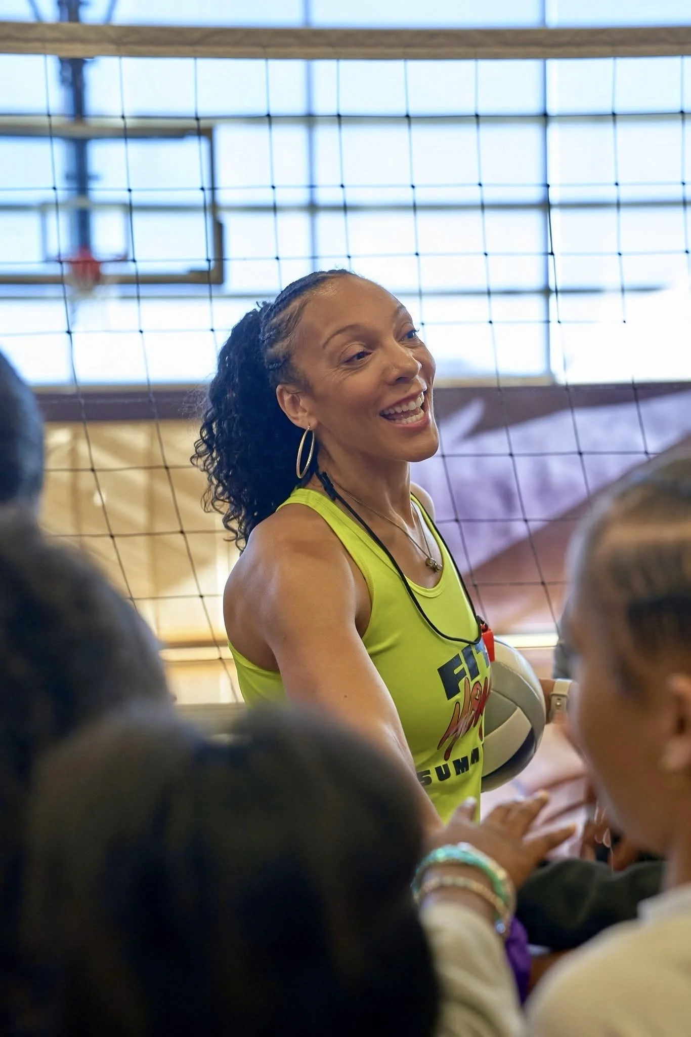 Coach Nik brings it in with kids in a group