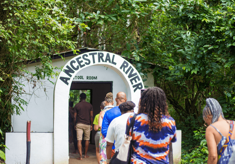 A group of travelers walking toward the ancestral rive entrance at Assin Manso slave river in Ghana