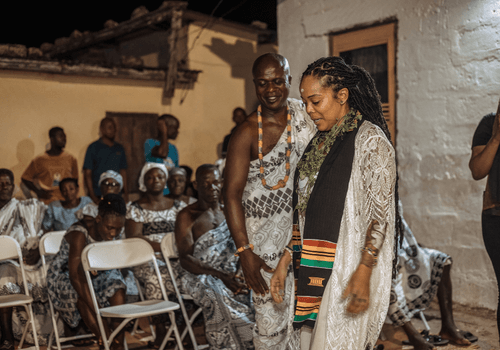 A photo of a female traveler taking part in a Ghana naming ceremony