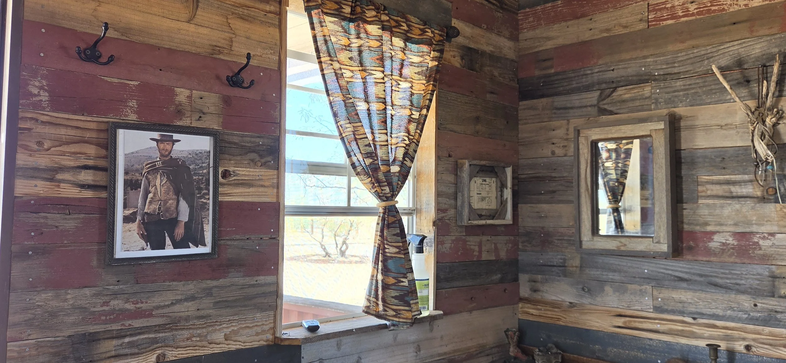 Entering The Eastwood on the left is an image of Clint Eastwood from a spaghetti western, the front window and an old mirror with wood trim