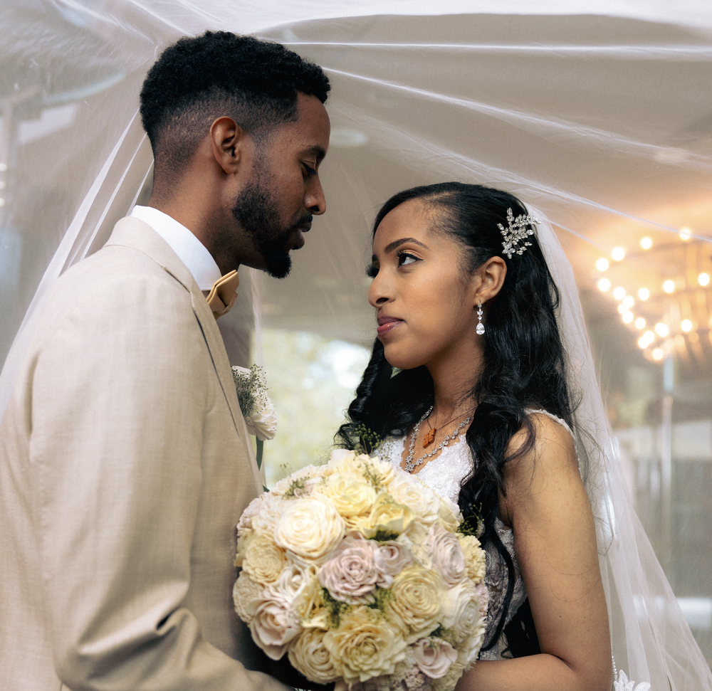 Couple under a wedding arch
