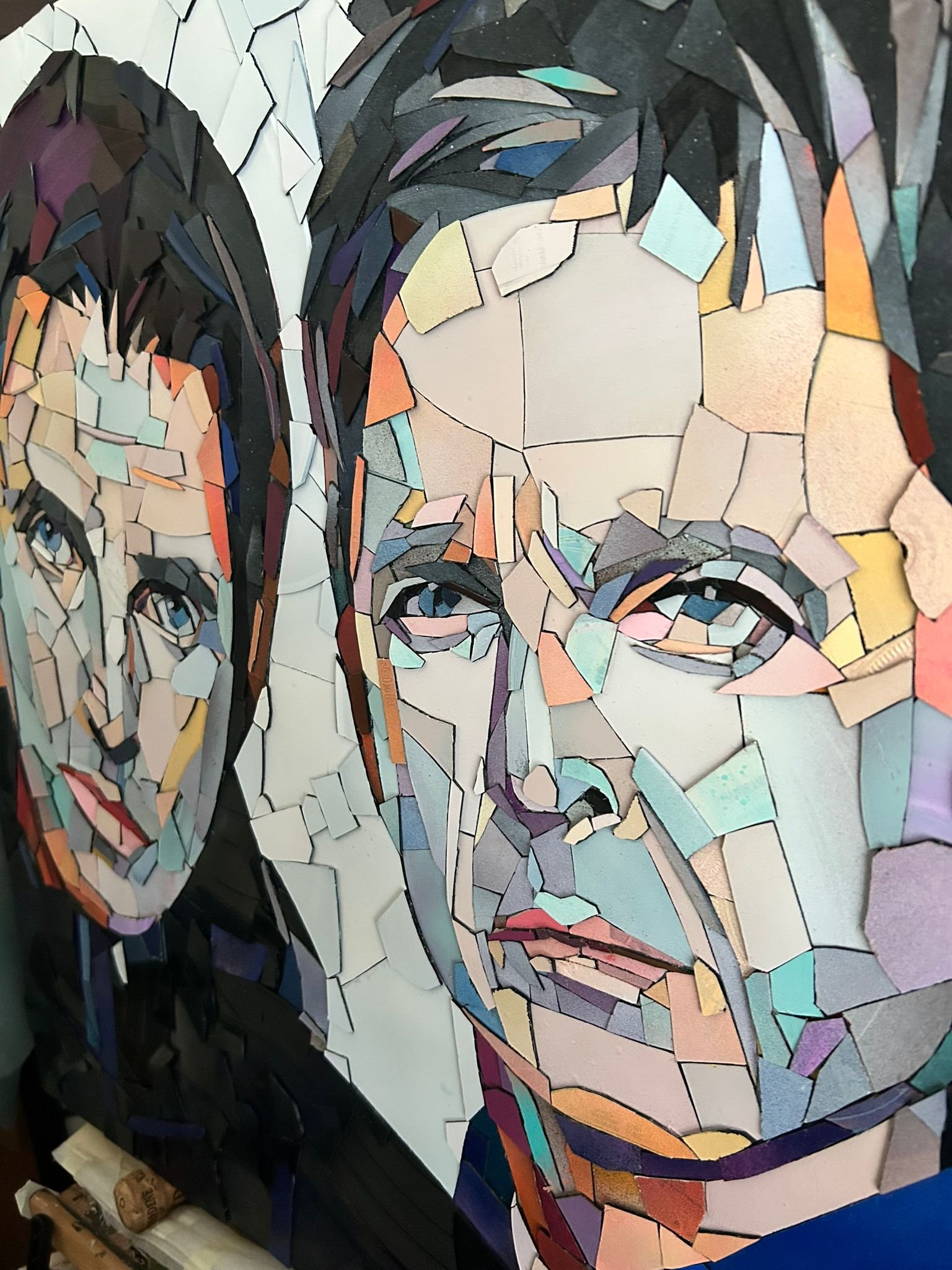 Ed Chapman, The Gallagher Brothers. Made from Hundreds of pieces of. vinyl records. . Individually applied. To produce a portrait of Liam Gallagher and Noel Gallagher. With bright, vibrant colours.