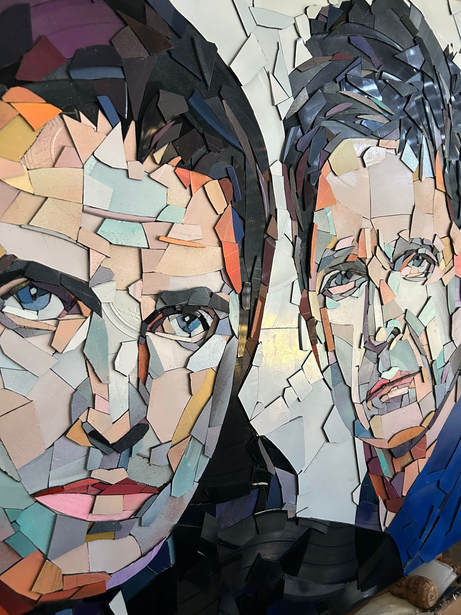 Ed Chapman, The Gallagher Brothers. Made from Hundreds of pieces of. vinyl records. . Individually applied. To produce a portrait of Liam Gallagher and Noel Gallagher. With bright, vibrant colours.