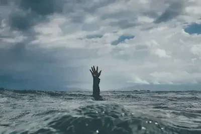 A gloomy image of a hand reach out from the ocean in desperation, the person underwater is nearly drowning in their depression