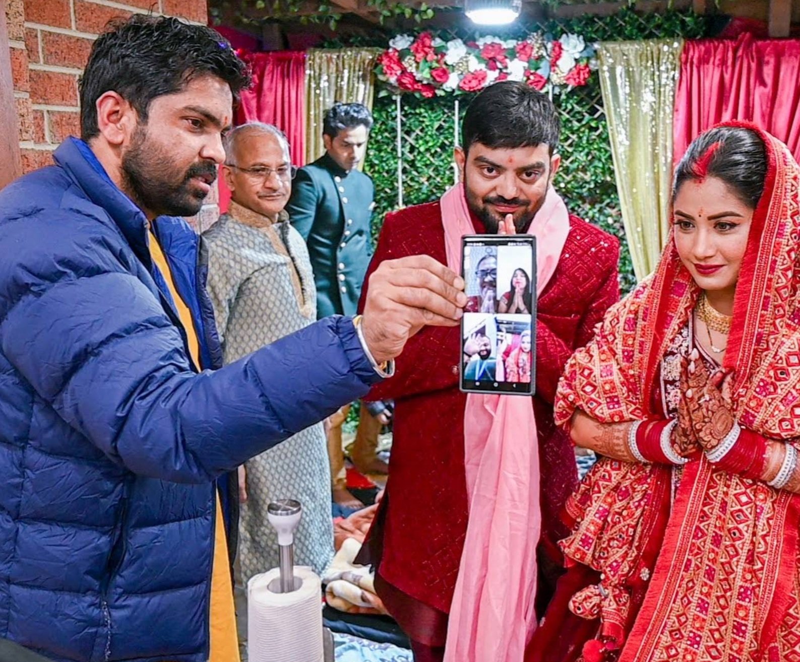Hindu priest Acharya Raj blessing a family during a pooja ceremony in Melbourne.