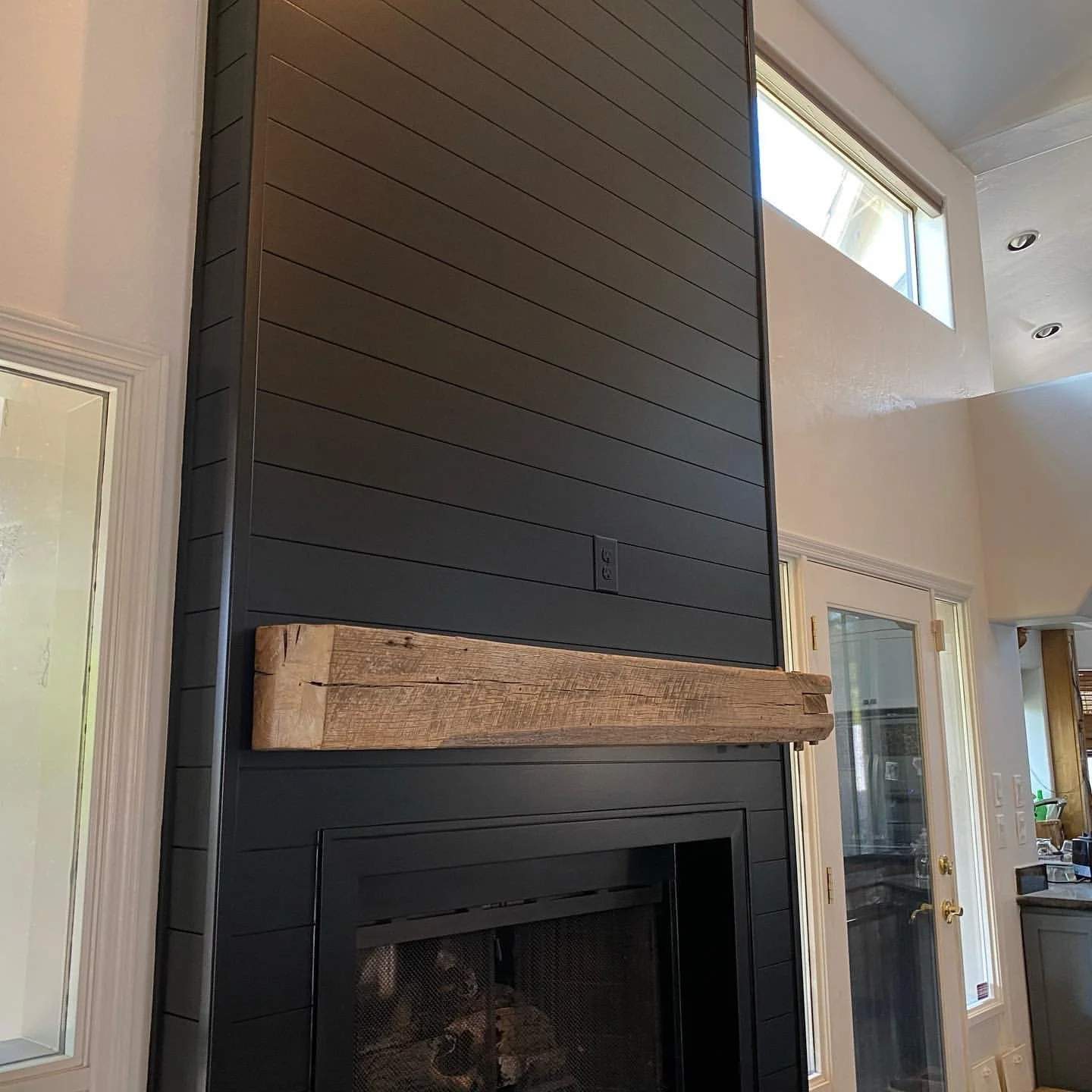reclaimed mantle with  black paneling