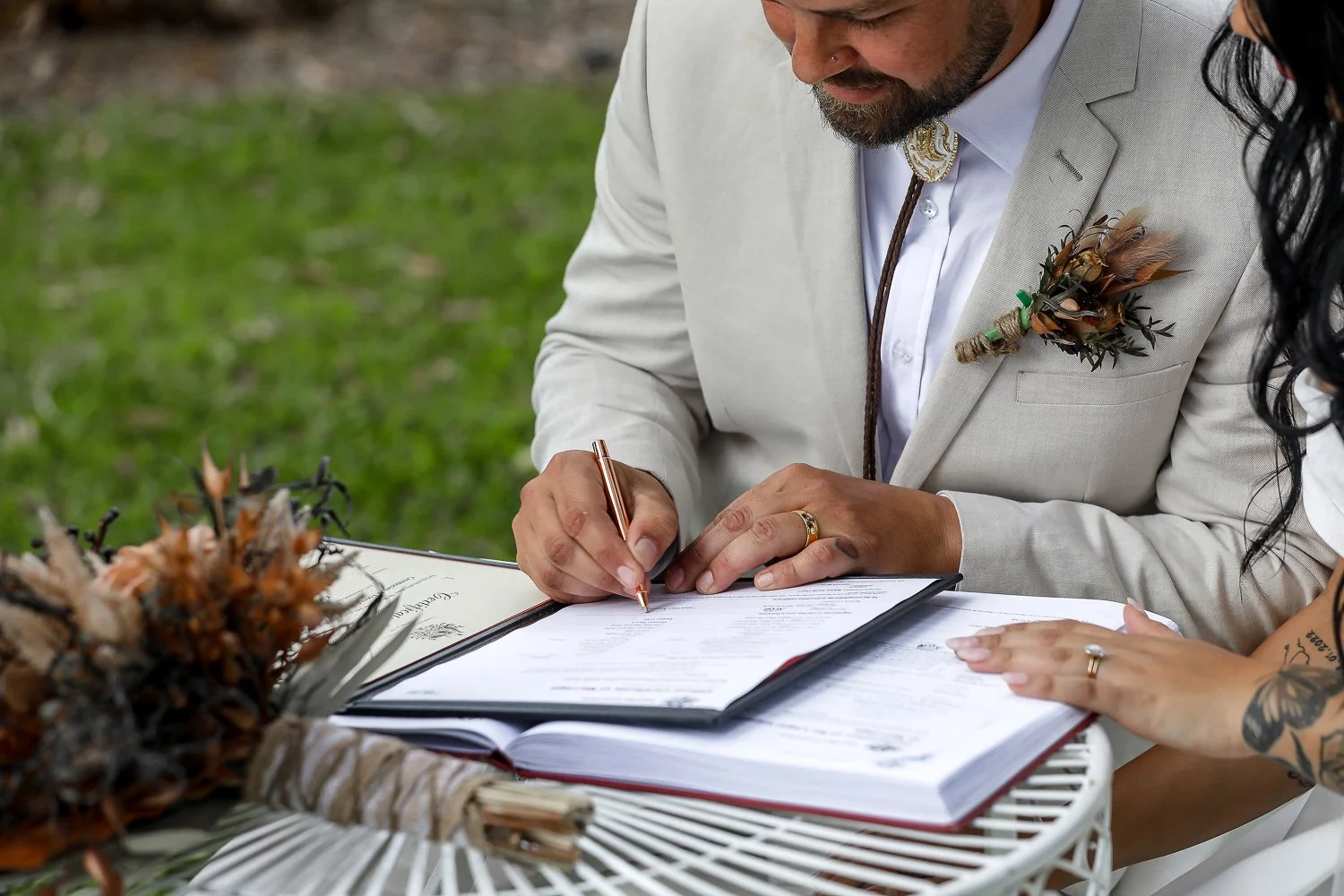 Groom signing wedding licence