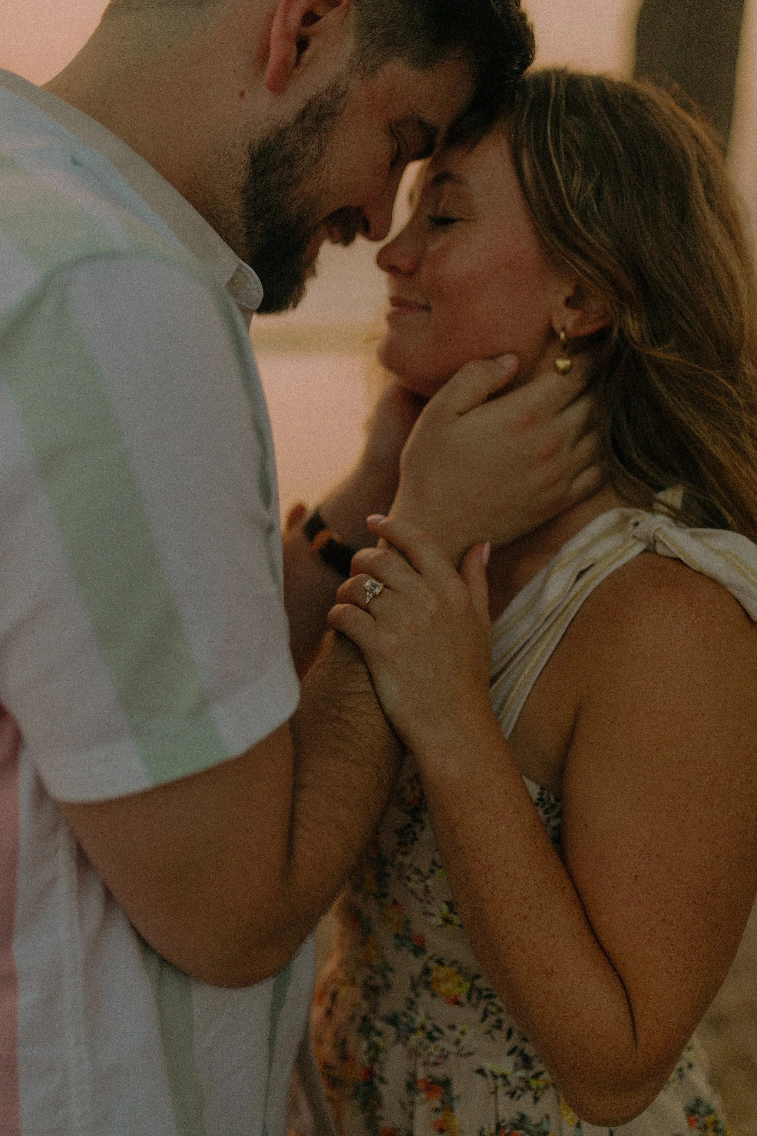 Close-up of a couple embracing with foreheads touching, showing affection.