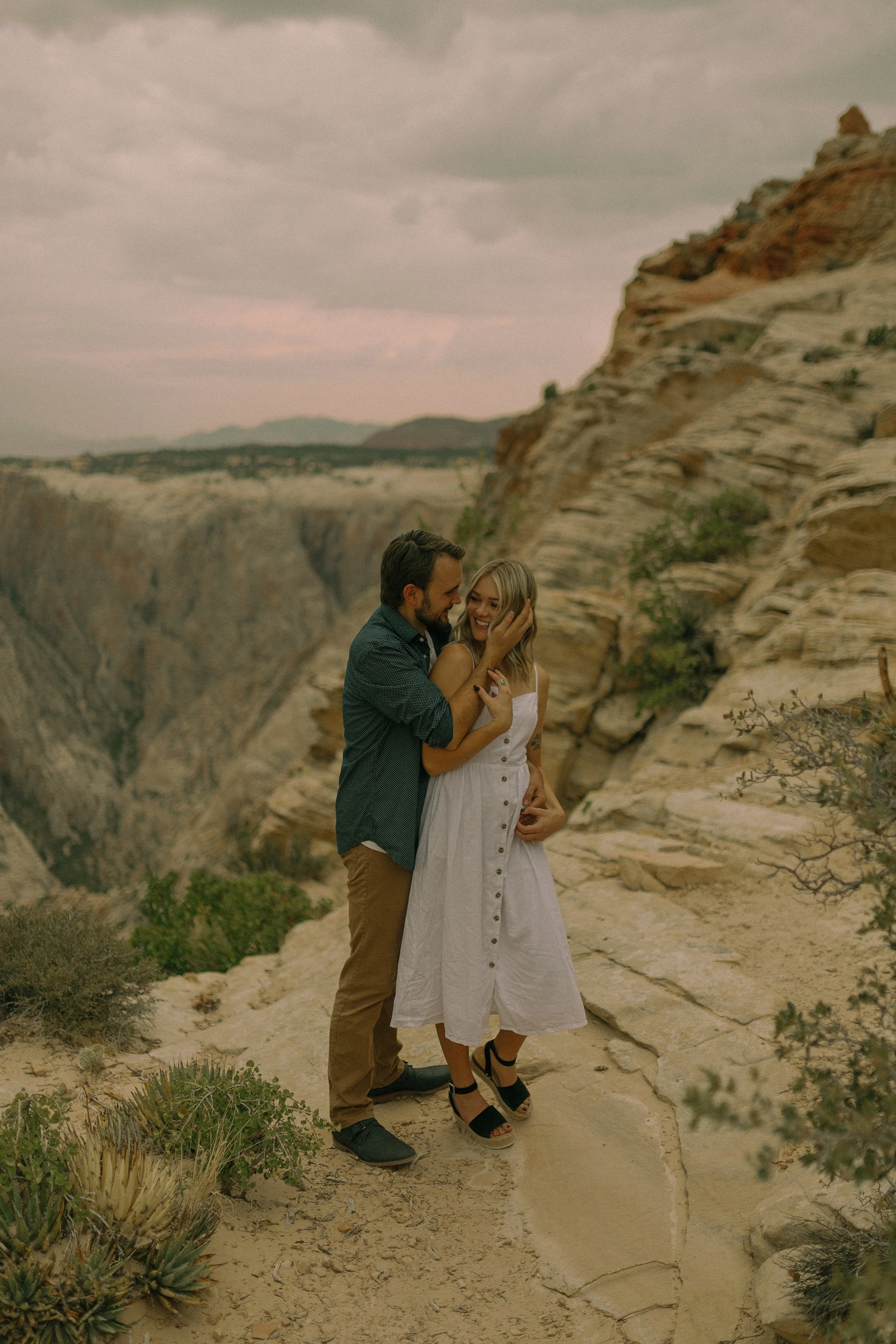 Couple embracing on rocky cliff