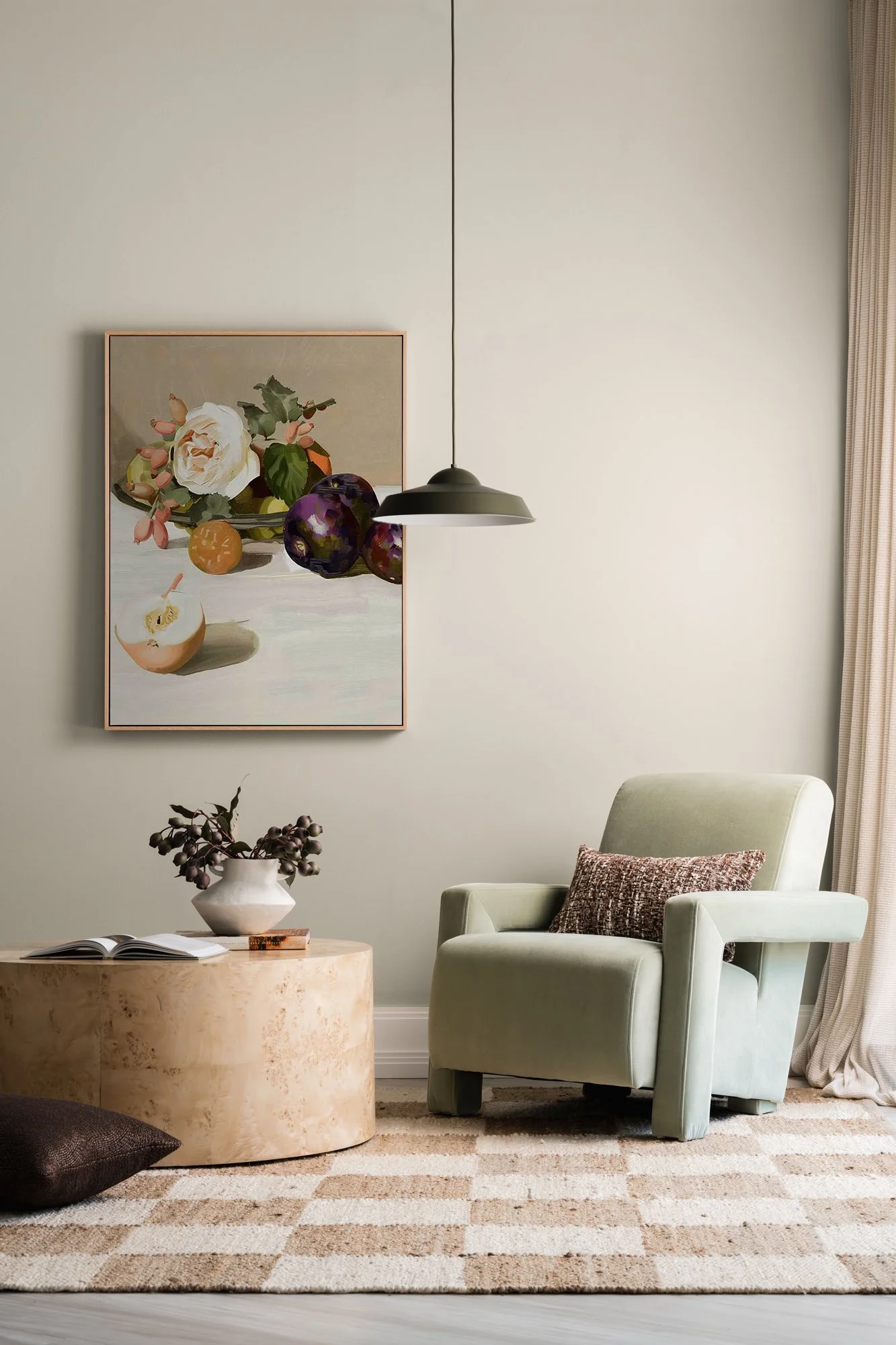 Styled photography set with floral artwork, sculptural pendant light, armchair and checkered rug