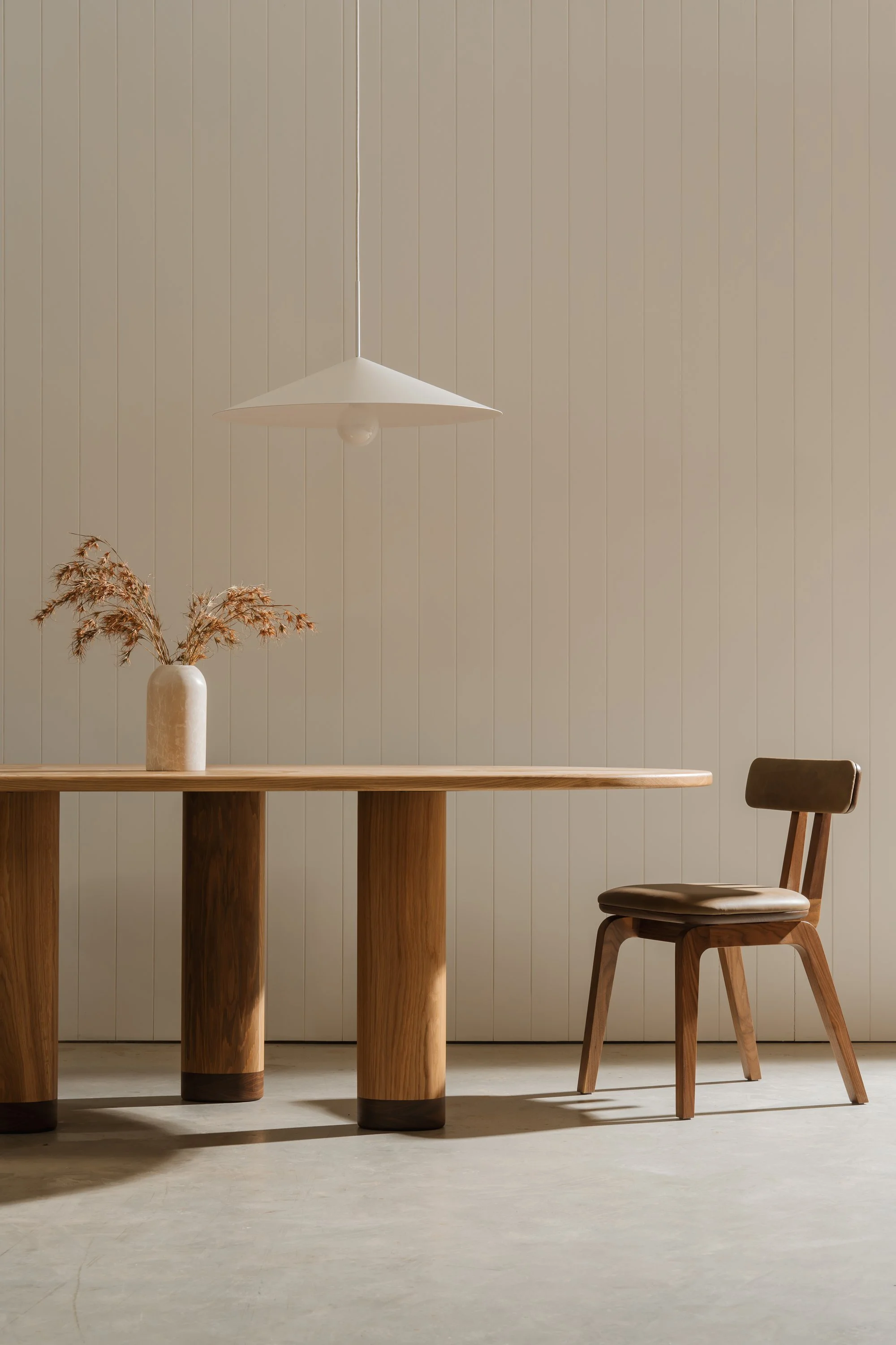 Minimal dining room set build with timber table, vintage chair, dried florals and soft natural light
