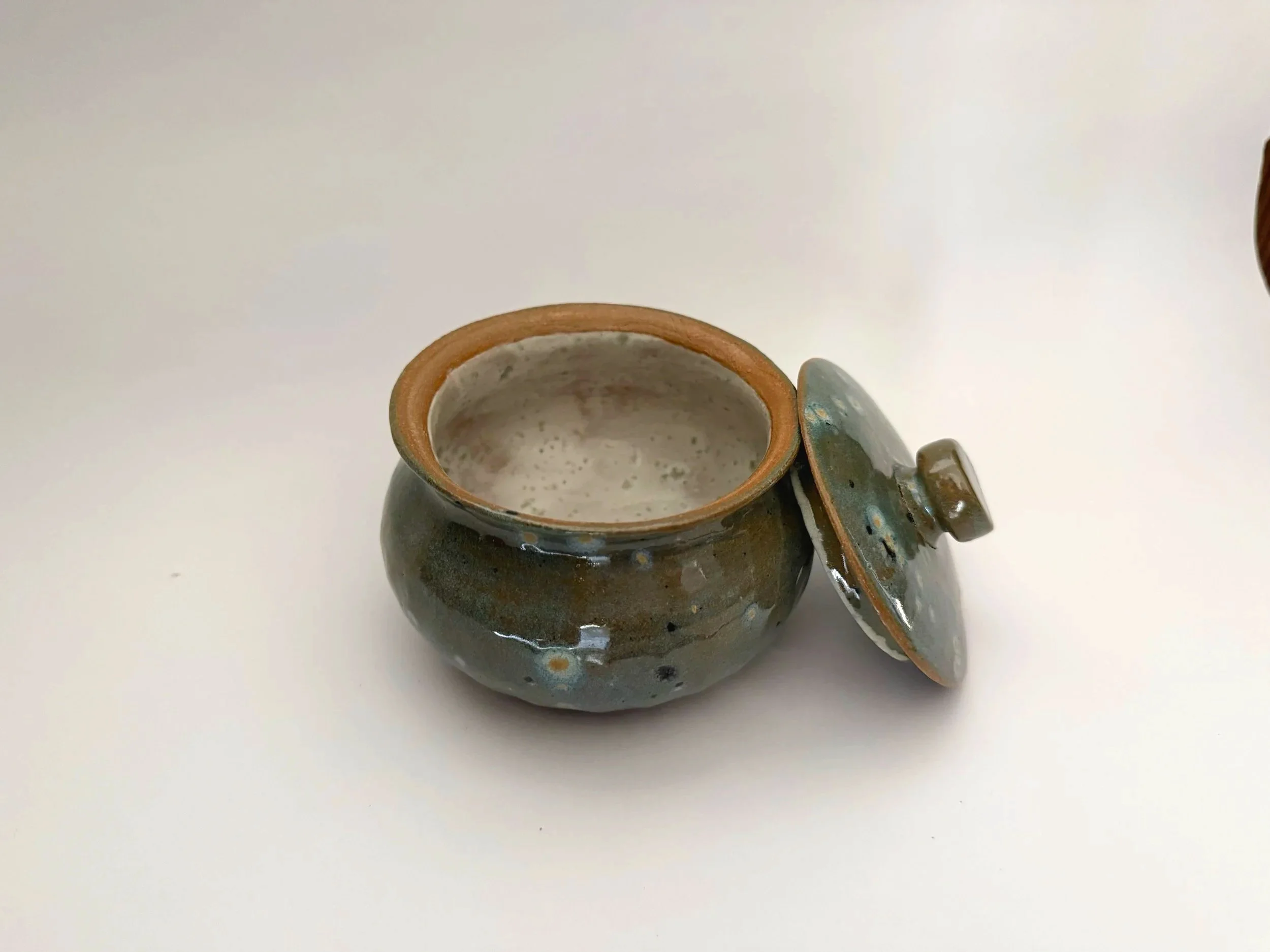 Small Lidded pot with spoon cutout