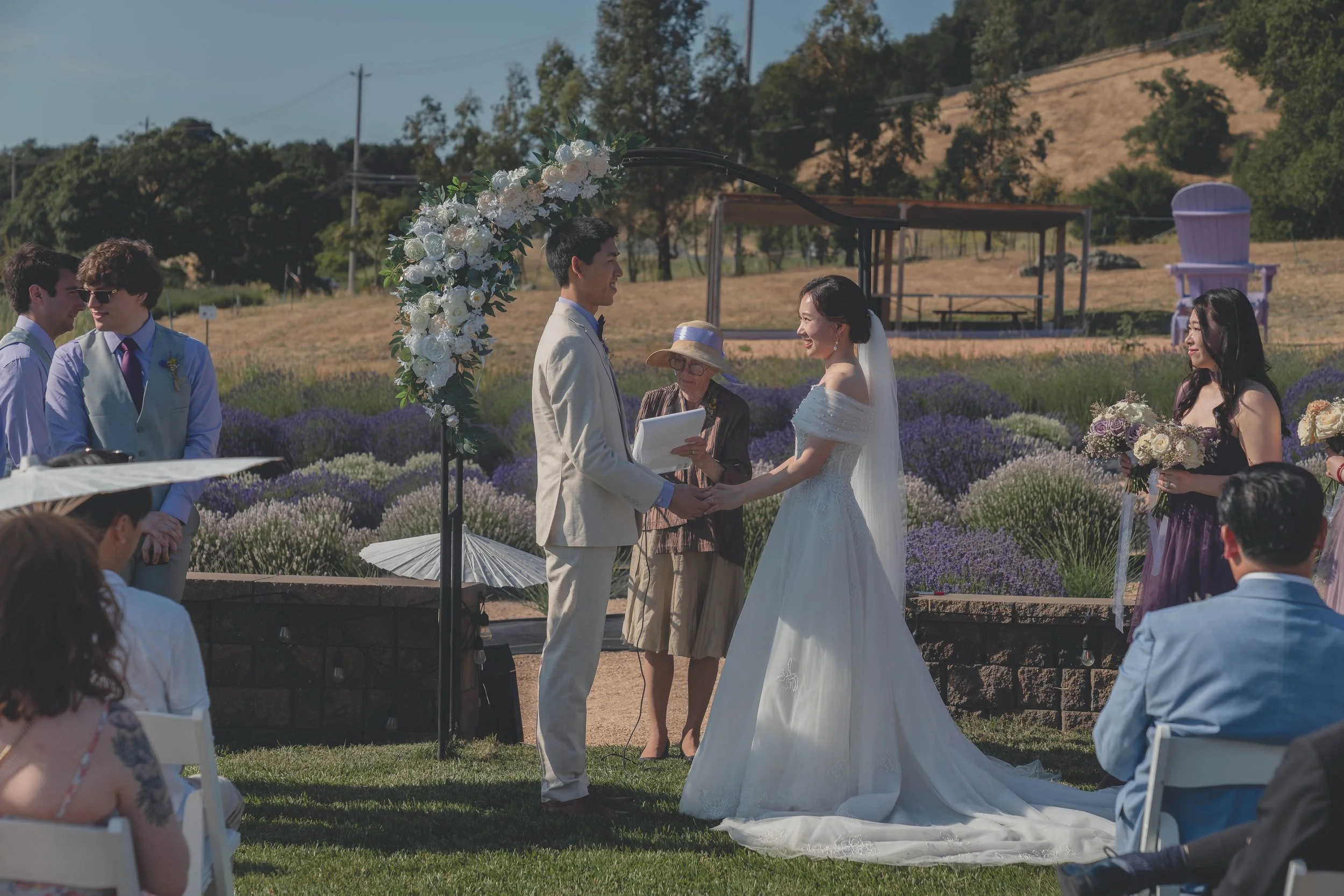 Bride and groom standing together as the ceremony nears its conclusion in Sonoma.