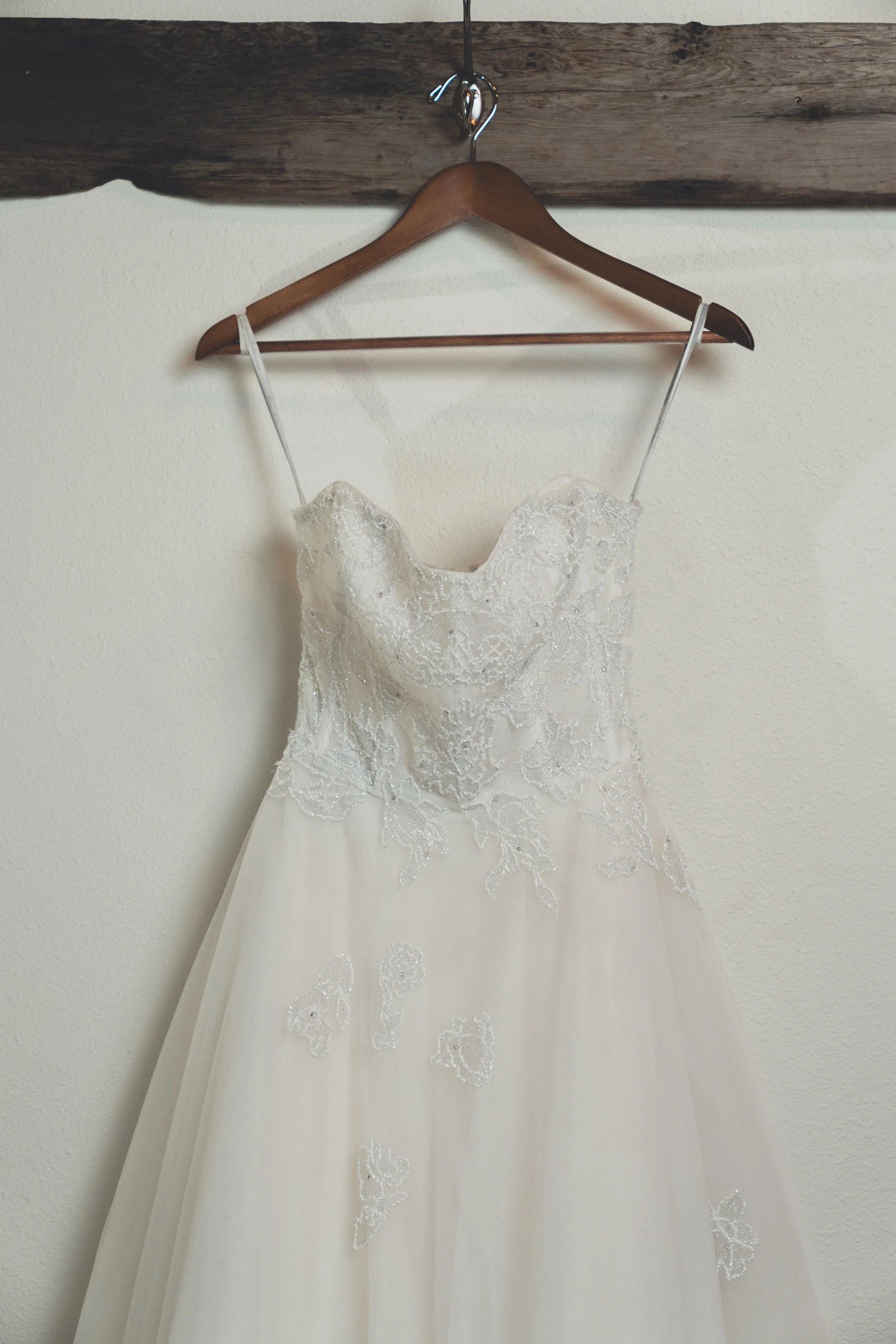 Hanging wedding dress detail captured before the ceremony in Sonoma.