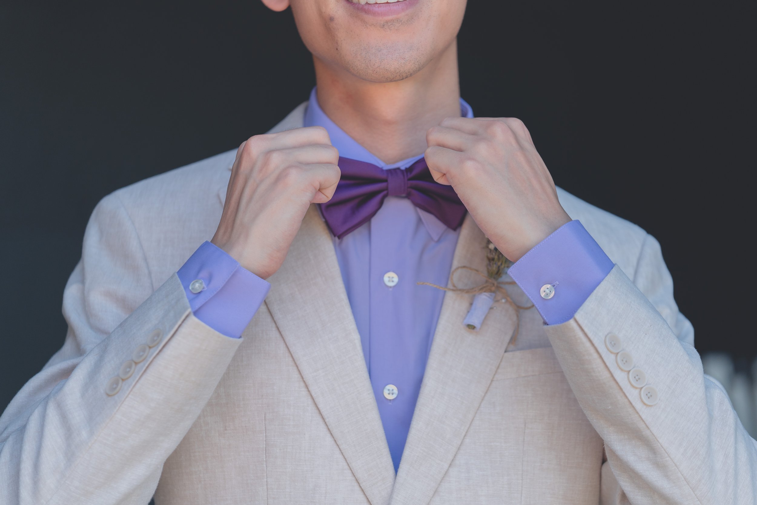 Groom adjusting his tie during pre-ceremony moments in Sonoma.
