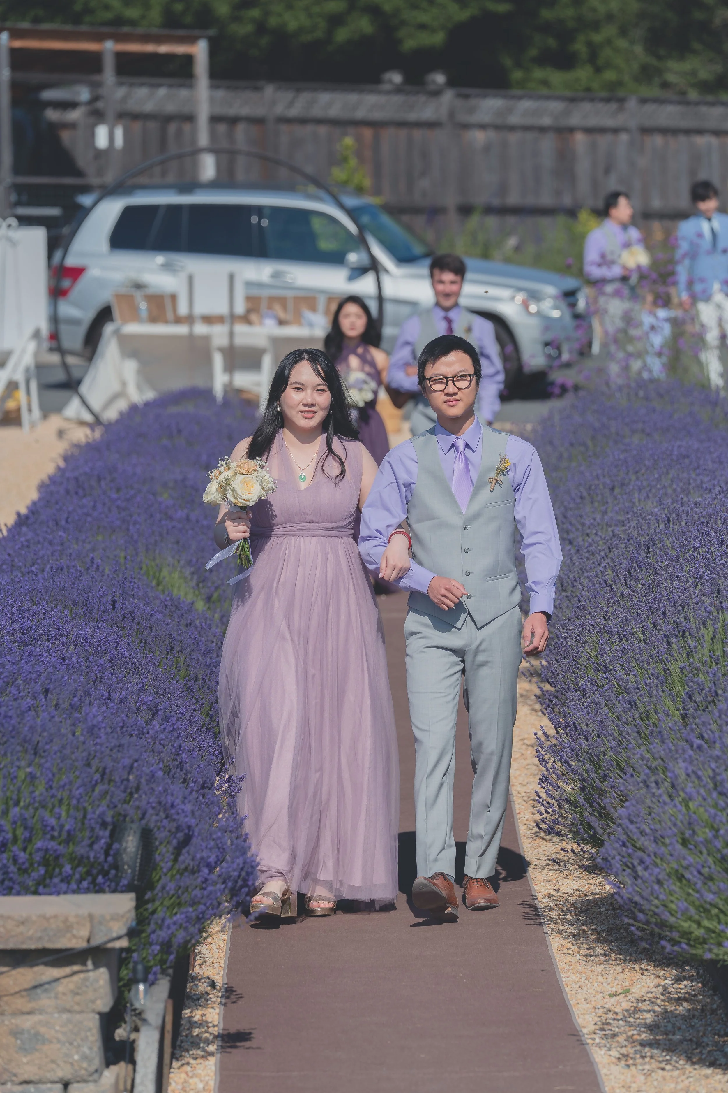 Bridesmaids walking together down the ceremony aisle during a Sonoma wedding.