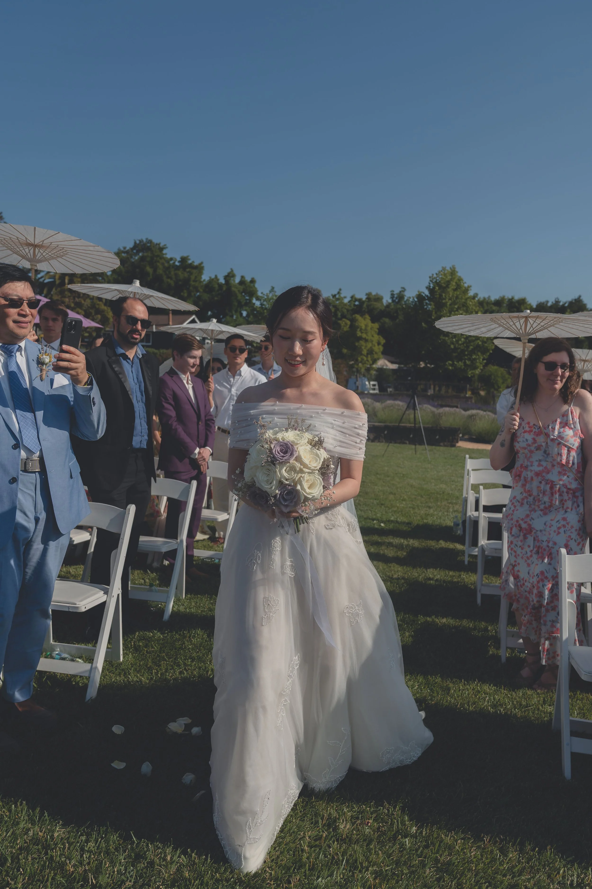 Bride arriving at the ceremony space as the wedding procession concludes in Sonoma.