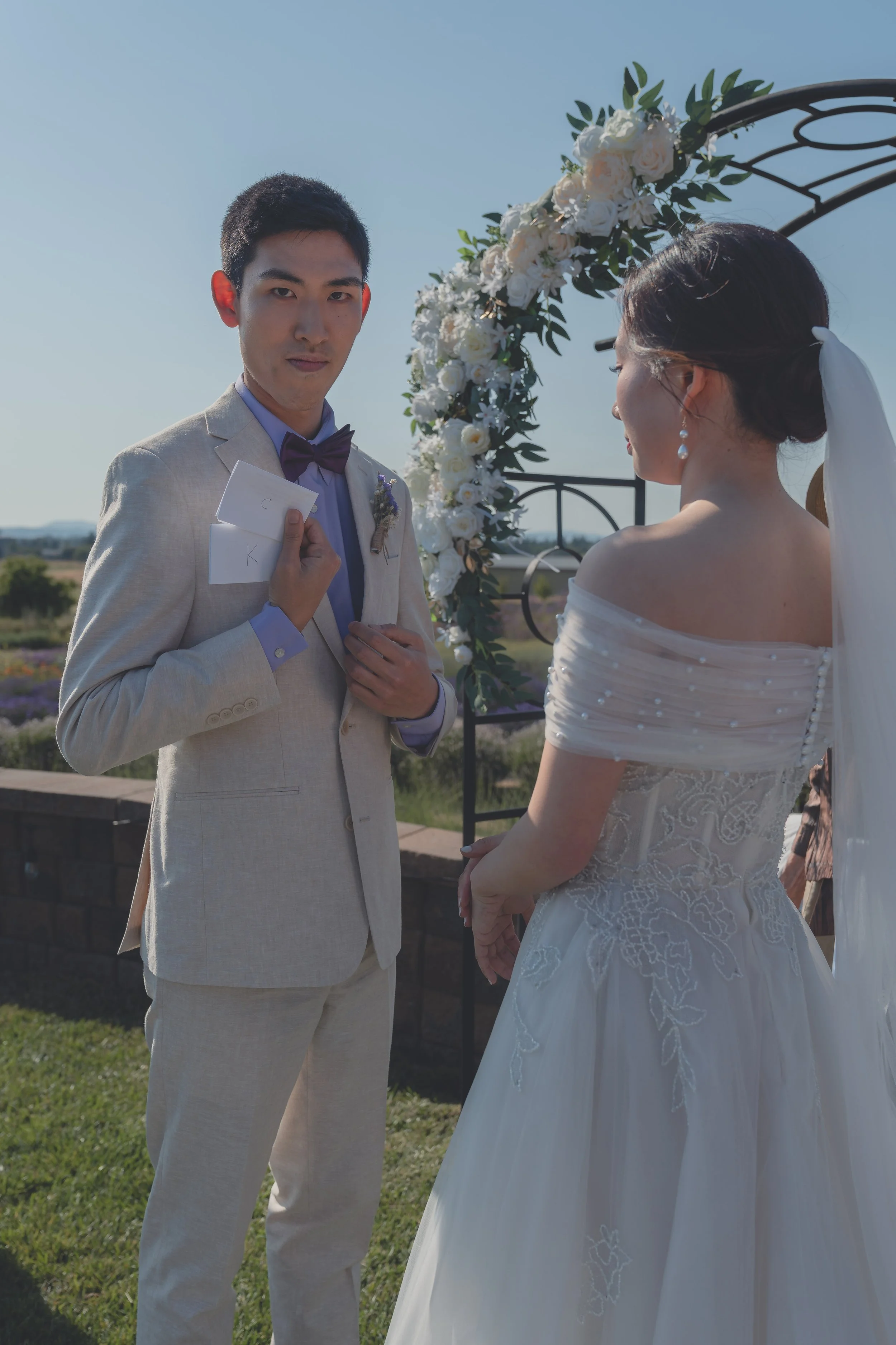 Groom speaking during the ceremony with the bride beside him in Sonoma.