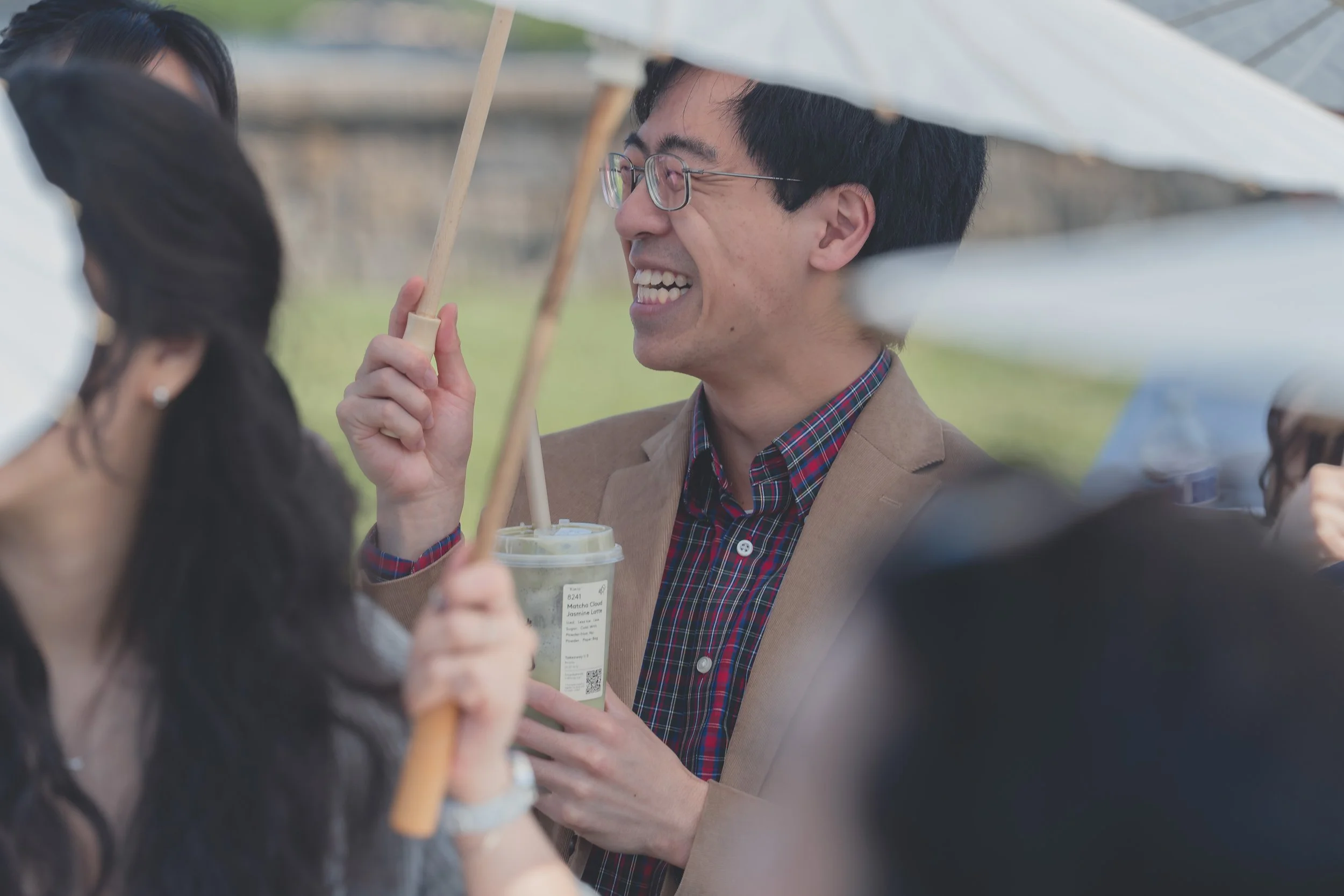 129. Guest holding a drink while watching the ceremony at a Sonoma wedding.

