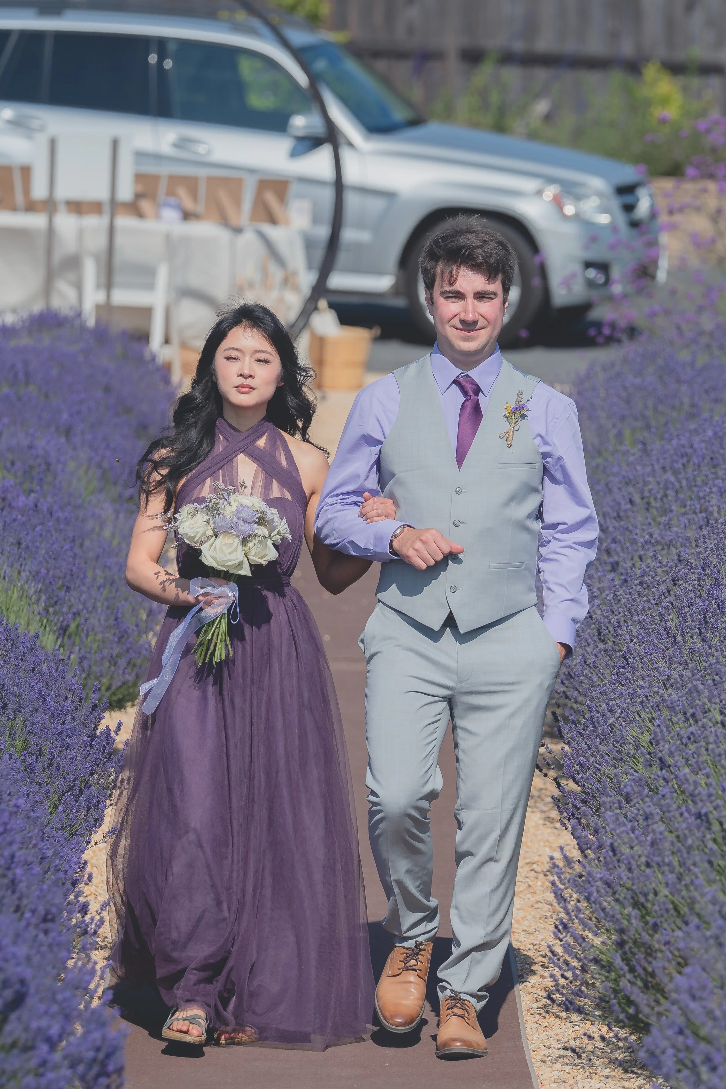 Bridesmaids entering the ceremony space framed by lavender fields in Sonoma.