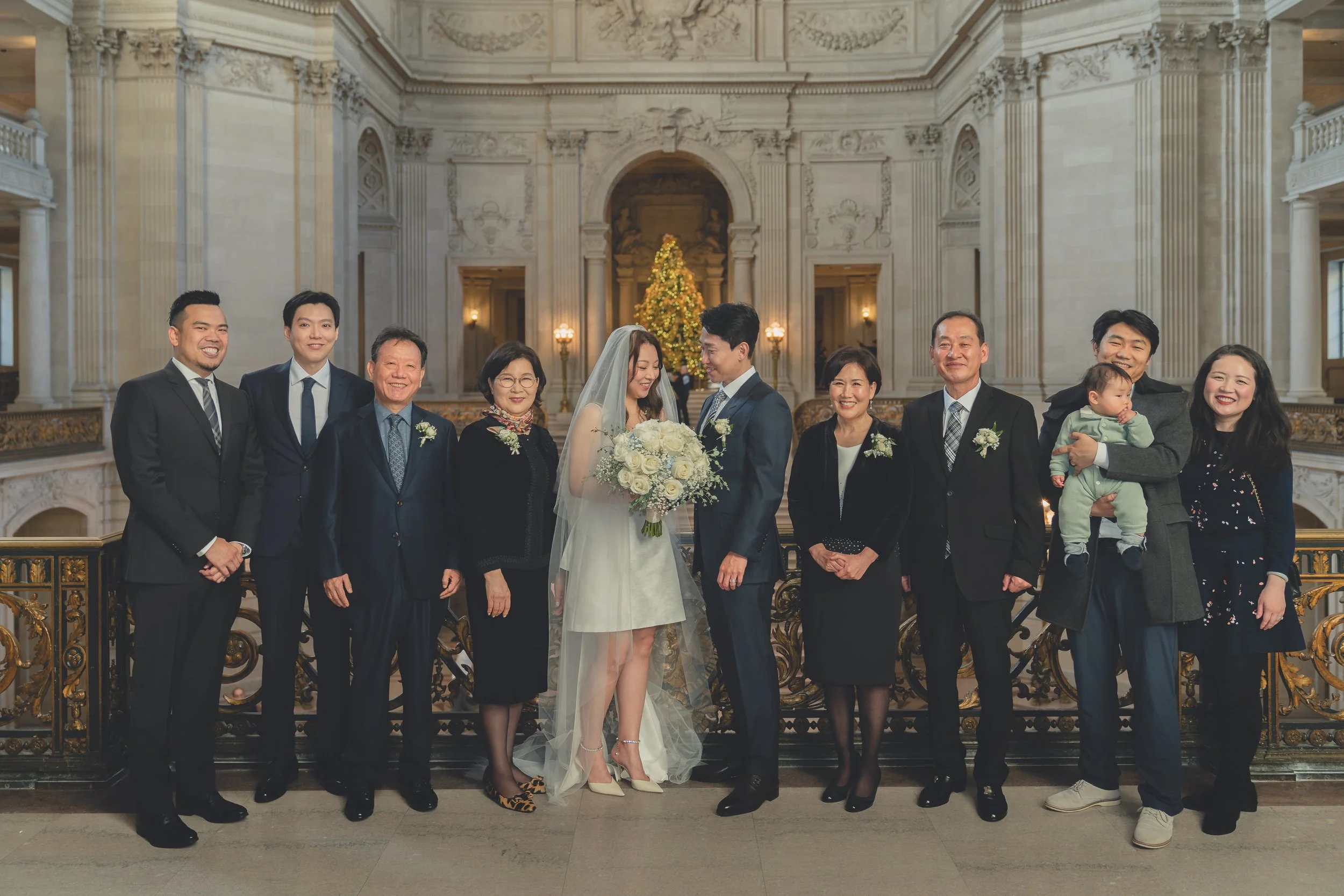 Emotional moment during a San Francisco City Hall wedding ceremony surrounded by close family and friends.
