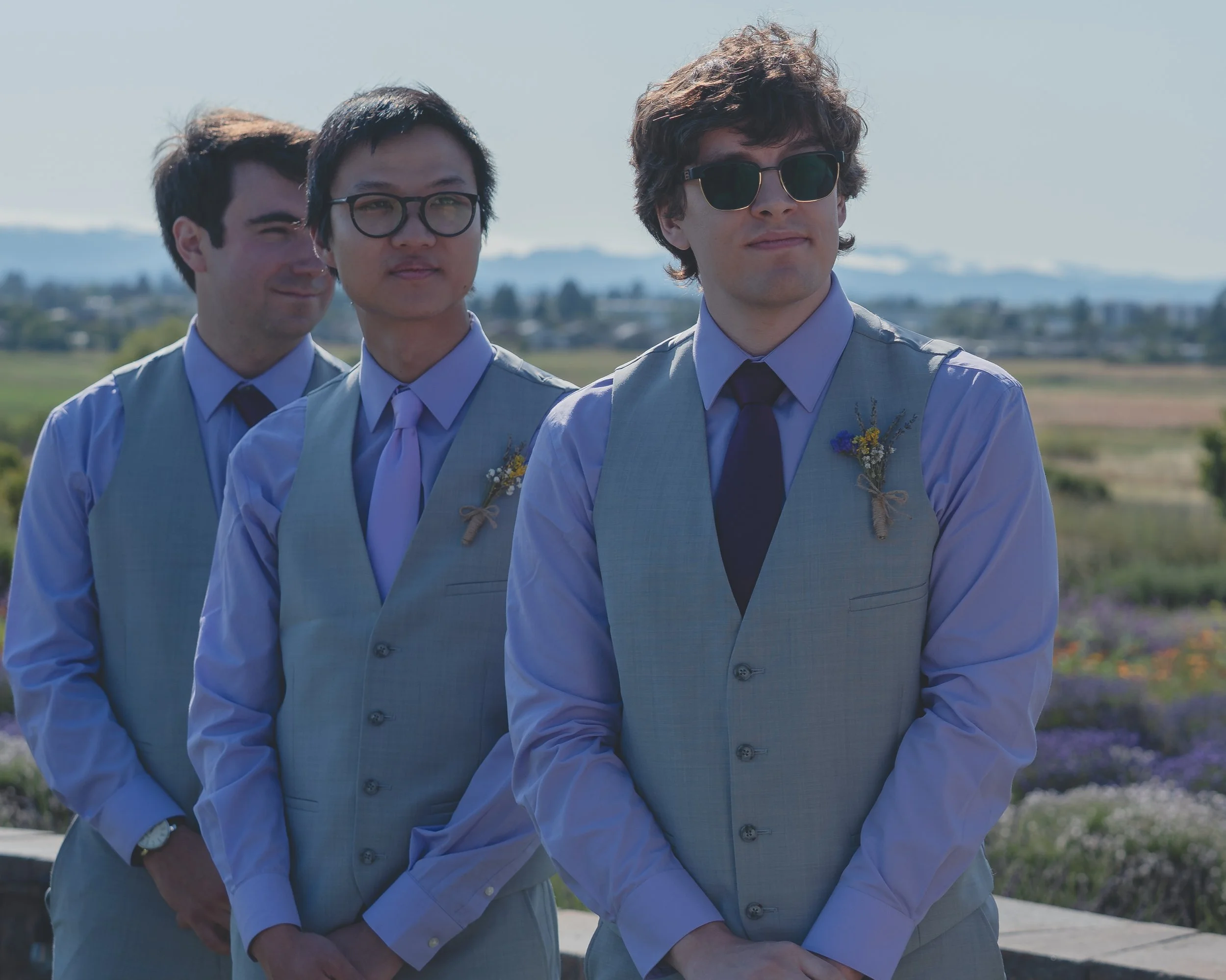 Groomsmen watching the ring exchange during the ceremony in California wine country.