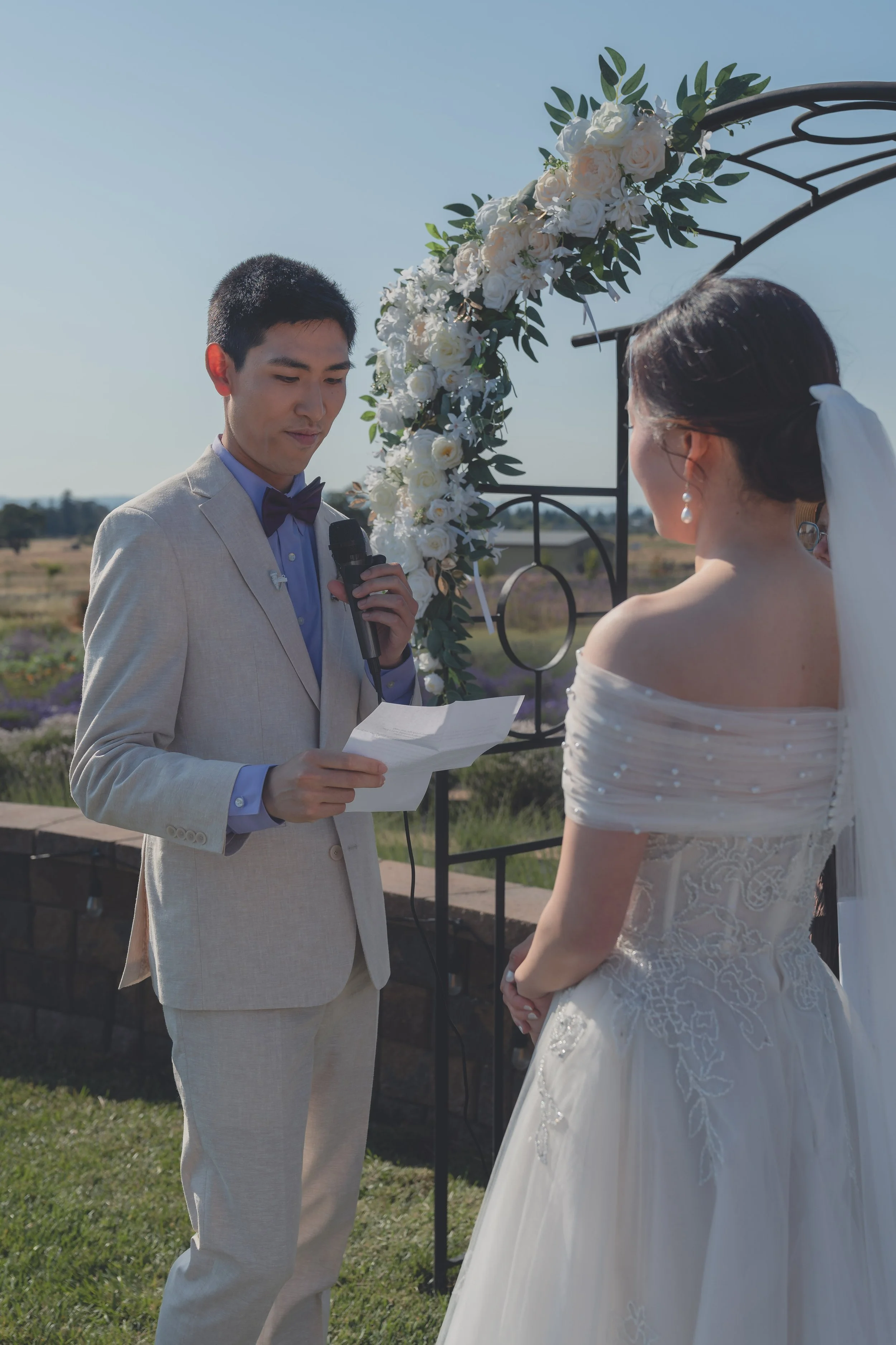 Bride listening as the groom speaks during the wedding ceremony in Sonoma.
