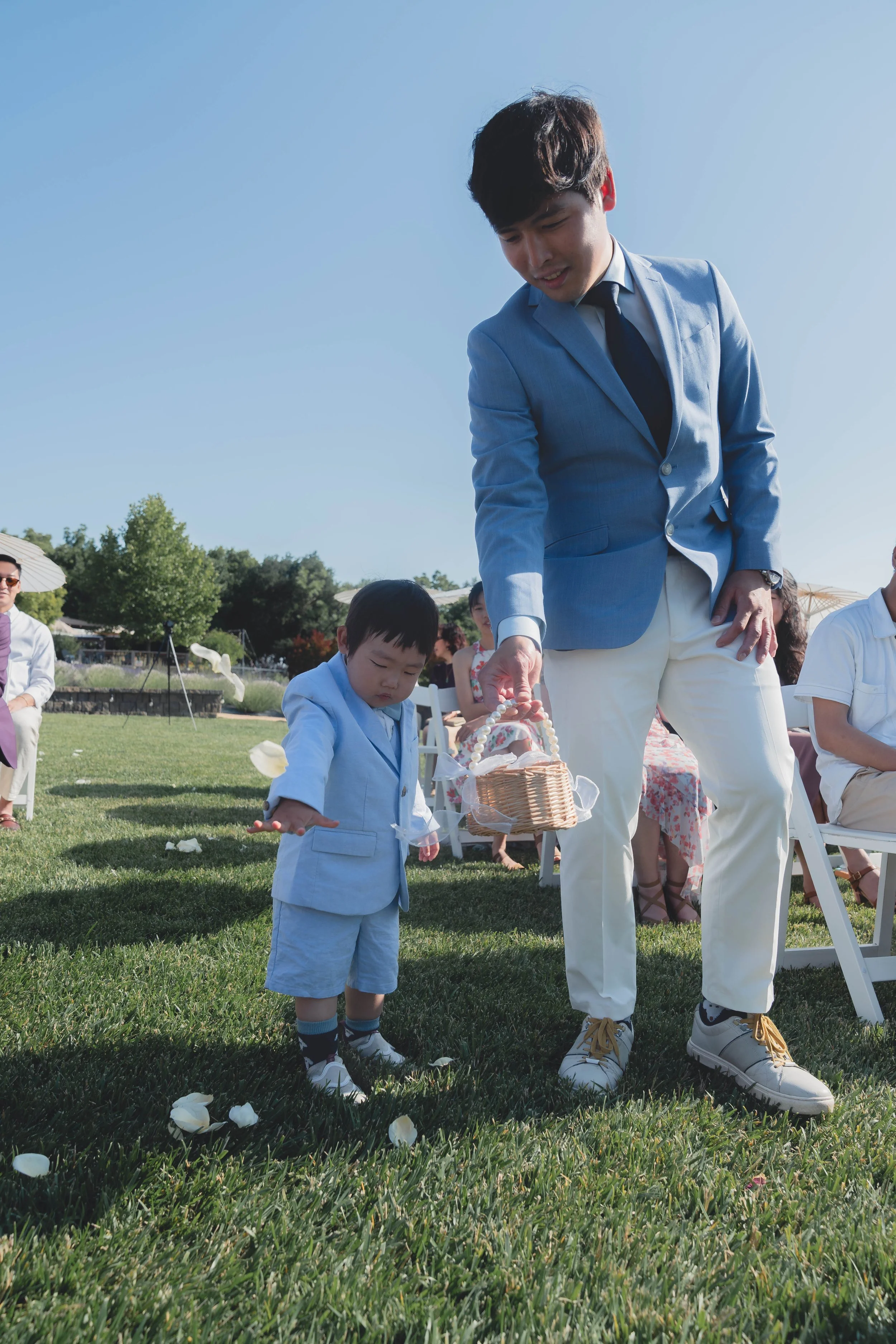 Groom watching as the flower boy walks down the aisle during the Sonoma ceremony.