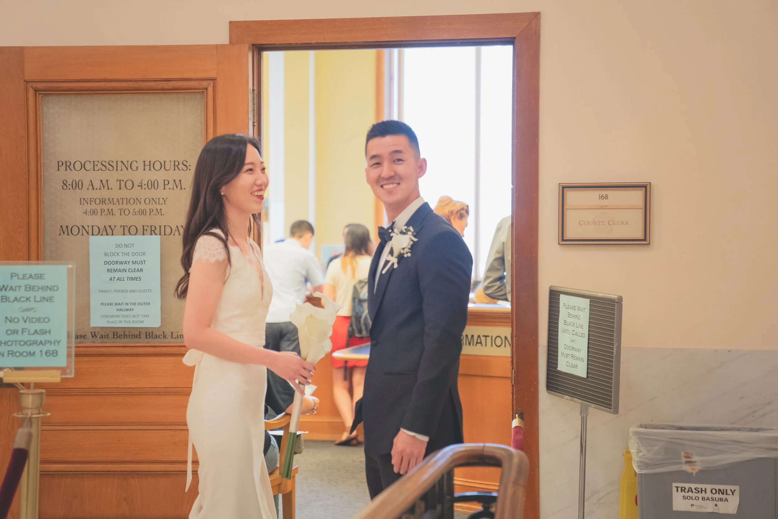 Couple signing marriage documents during their San Francisco City Hall civil wedding.