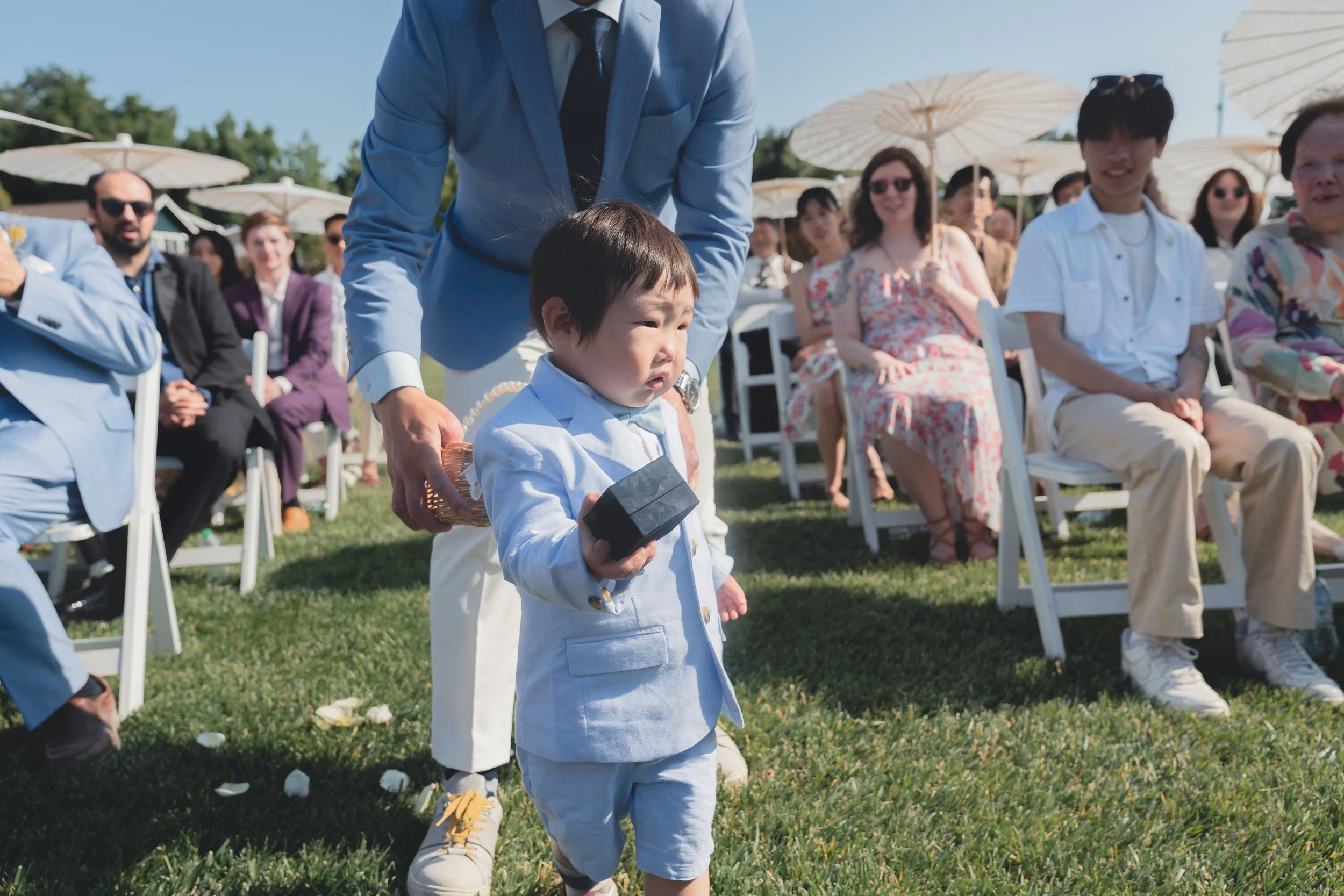 Candid moment of the flower boy during the wedding procession in Sonoma.