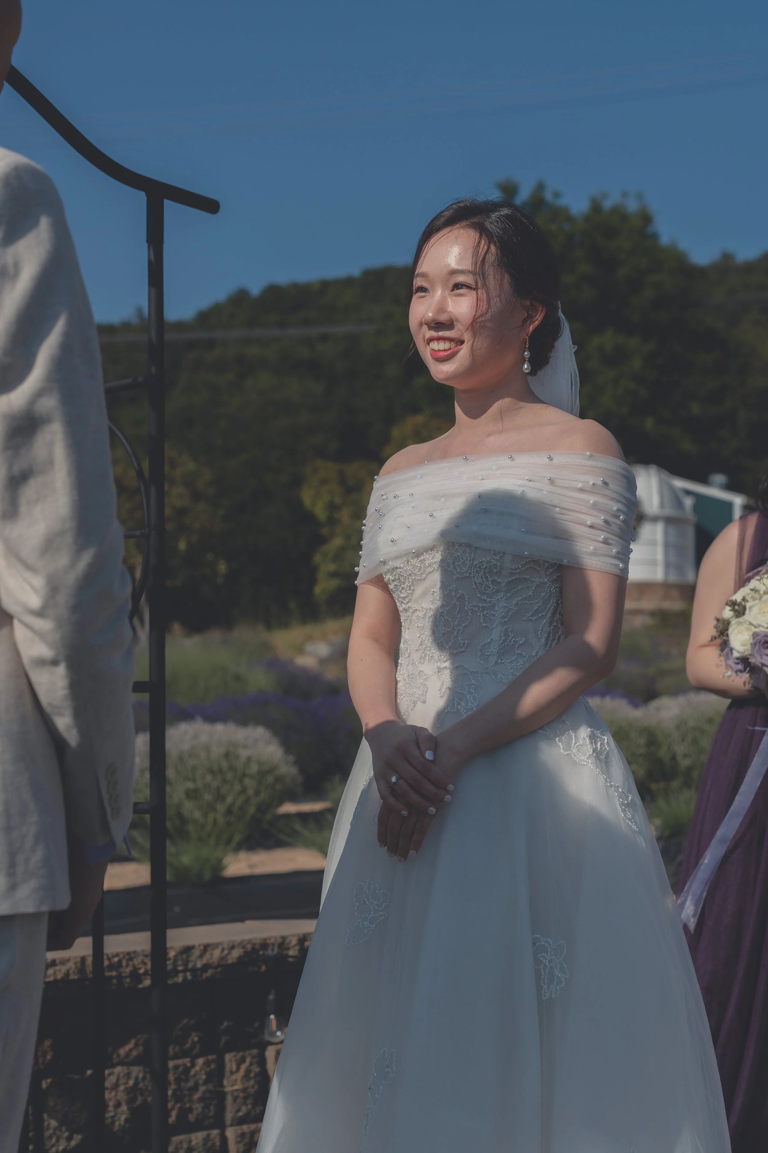Bride smiling softly during the ceremony in California wine country.