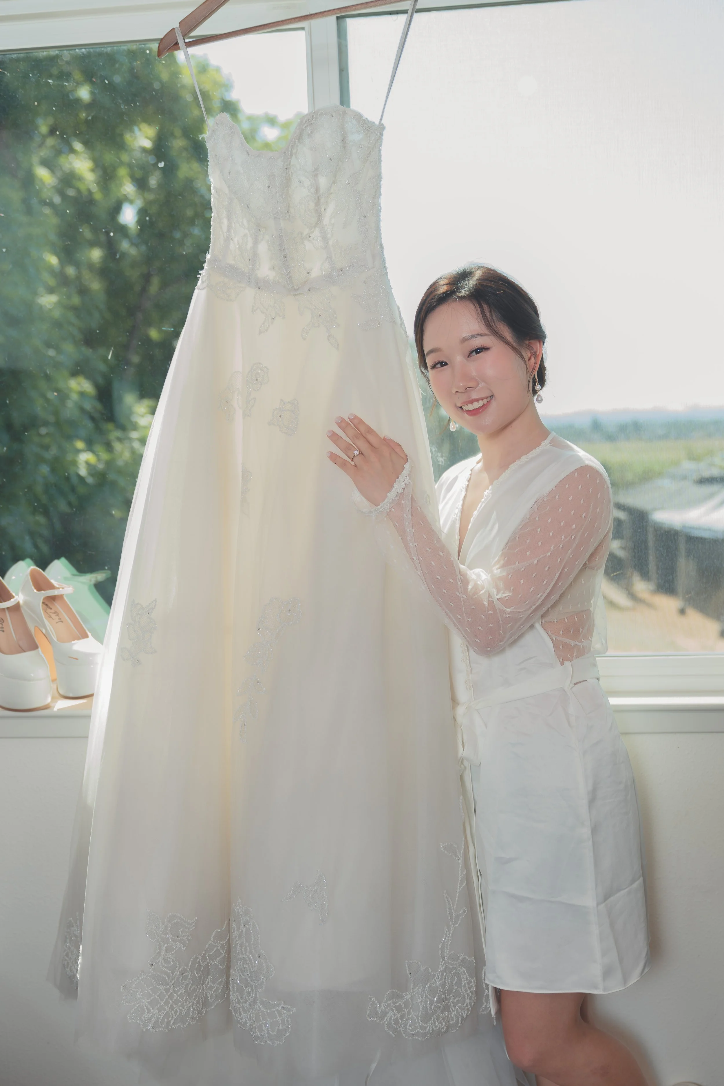Bride holding her wedding dress during a quiet moment before the ceremony at a Sonoma wedding.

