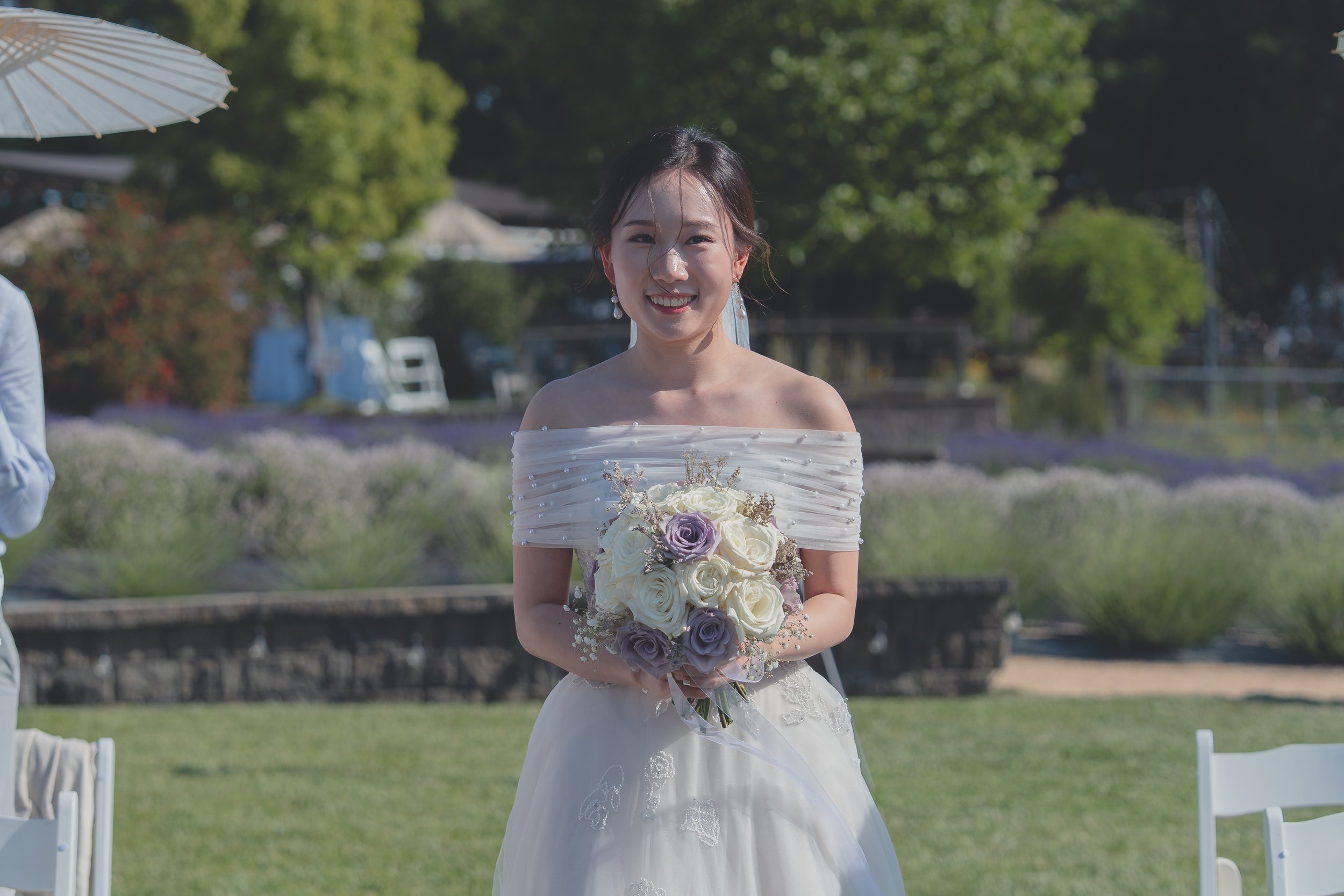 Bride smiling as she approaches the ceremony during a Sonoma wedding celebration.