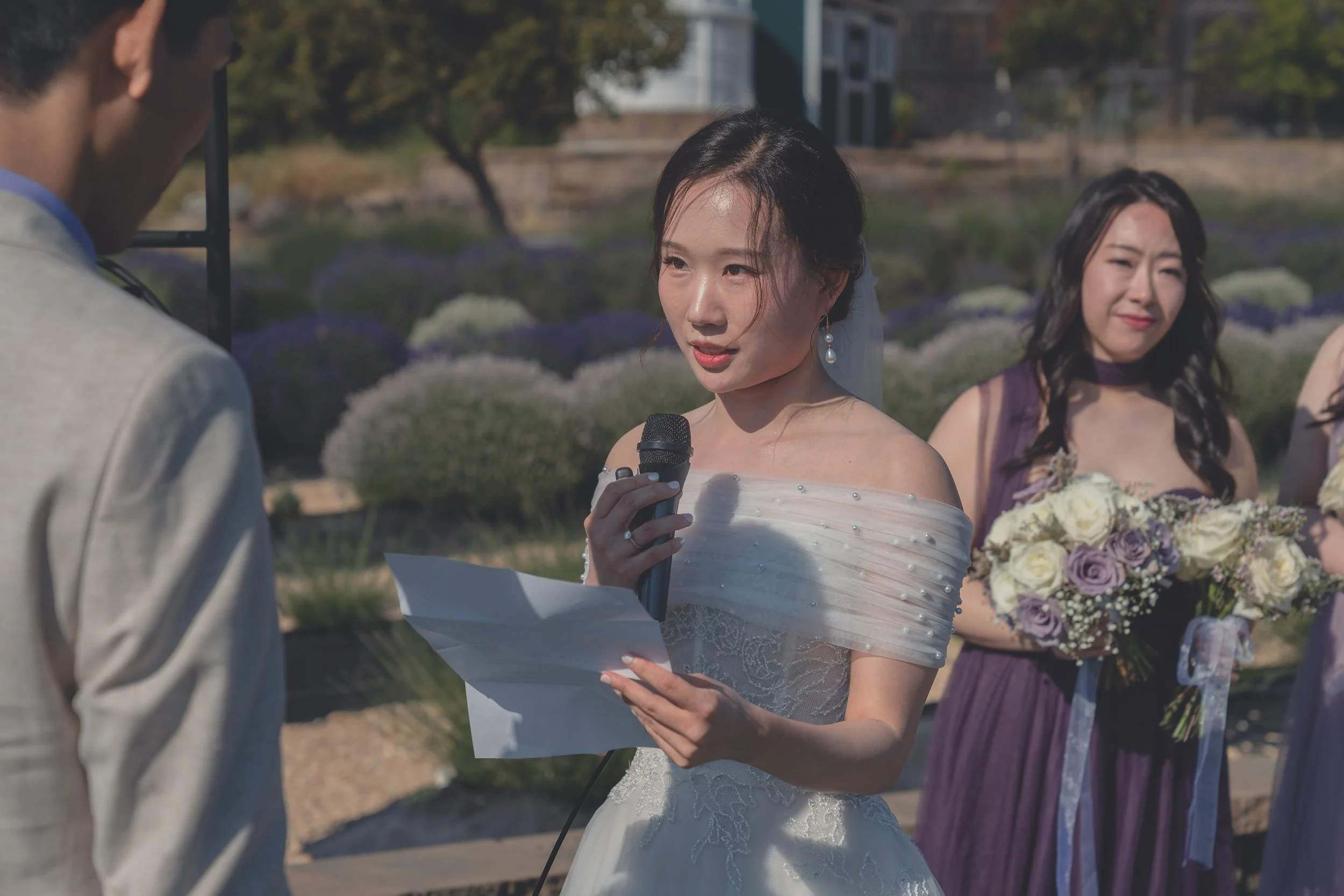 Bride holding her bouquet while listening during the wedding ceremony in Sonoma.