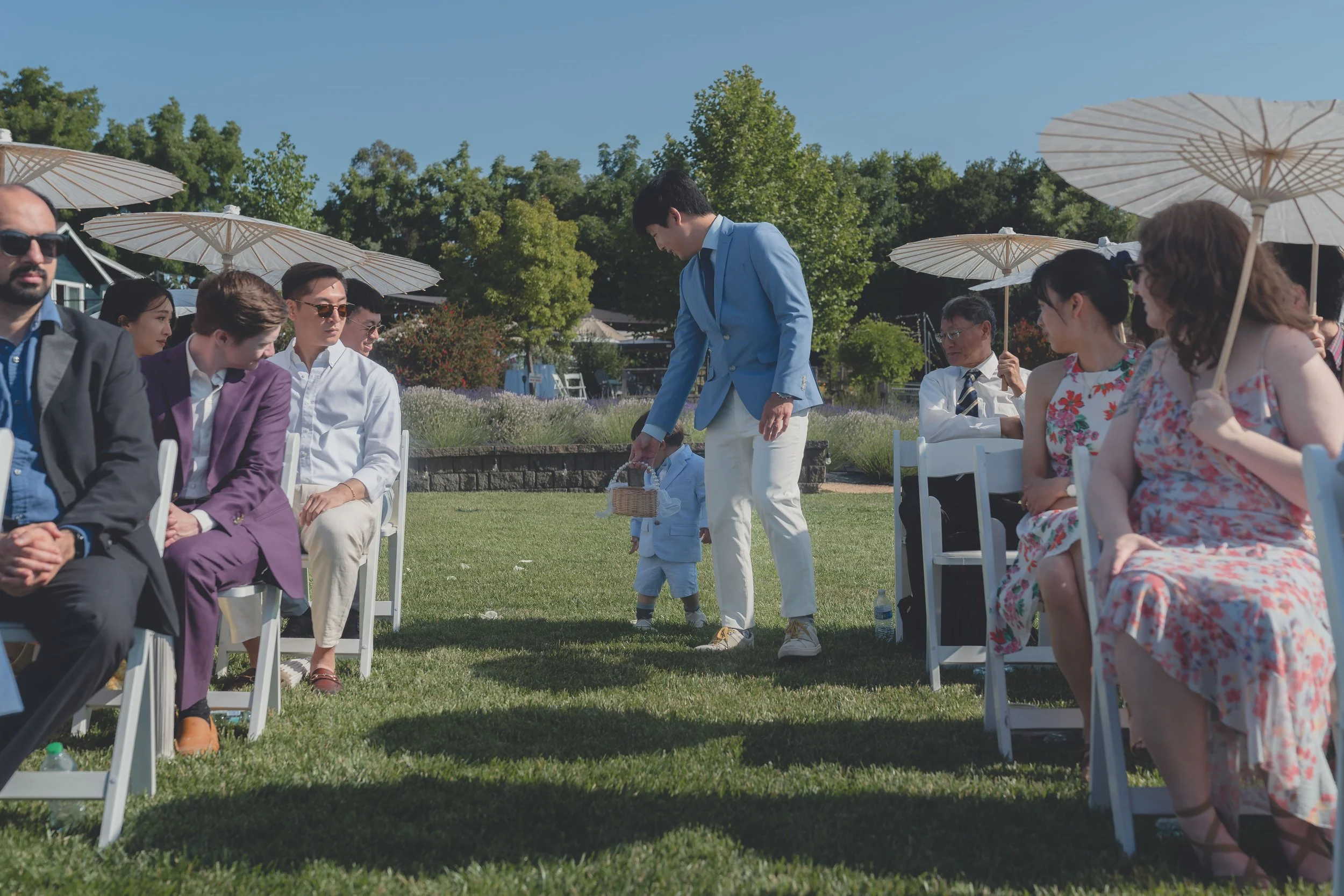 Flower boy stepping forward during the ceremony procession at a Sonoma wedding.