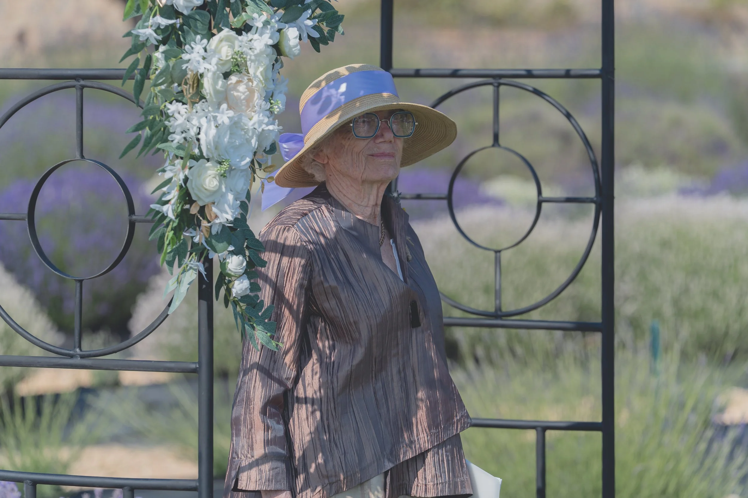 Guest holding a wedding program during the ceremony at a Sonoma wedding.