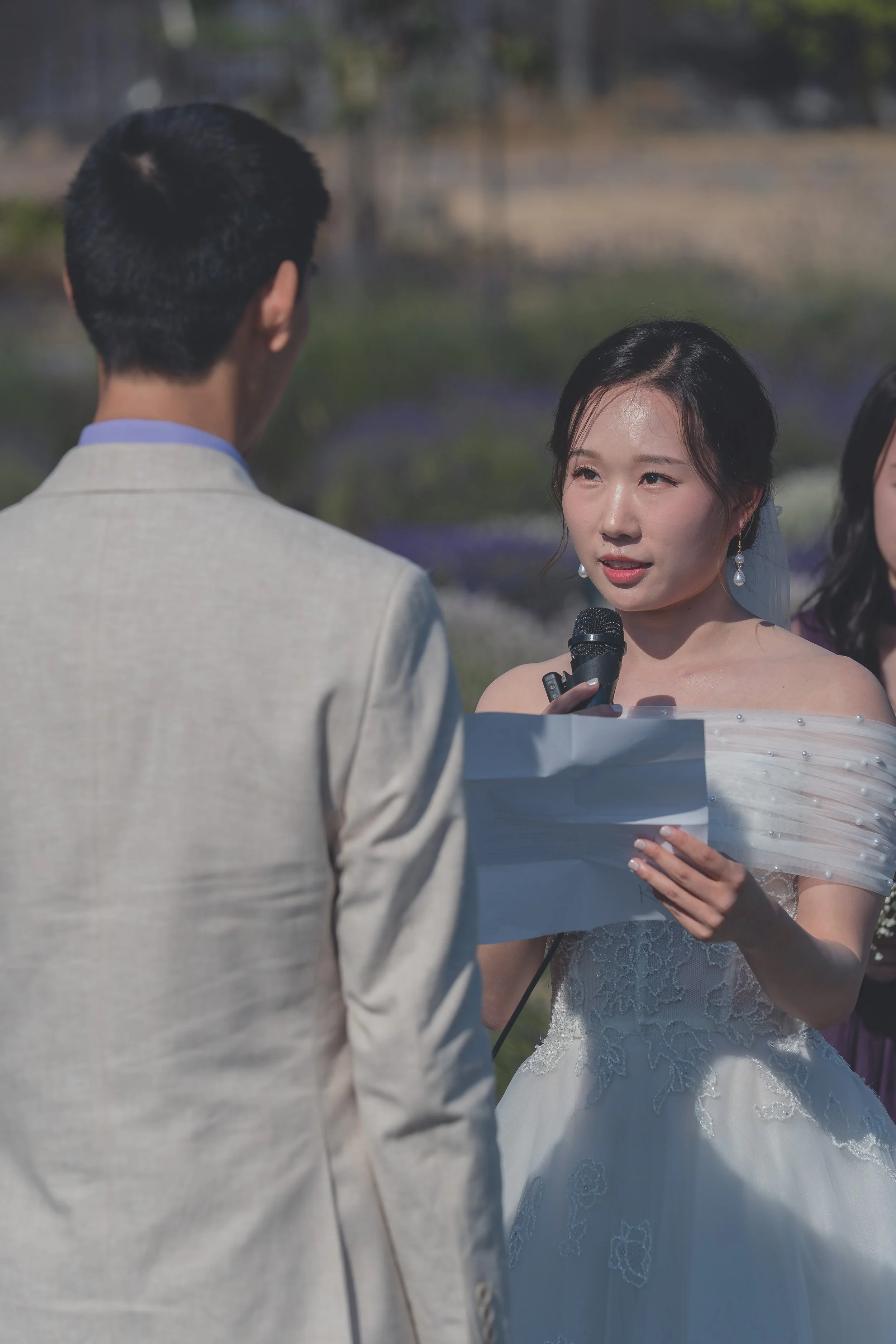 Bride listening intently as vows are read during the Sonoma wedding ceremony.