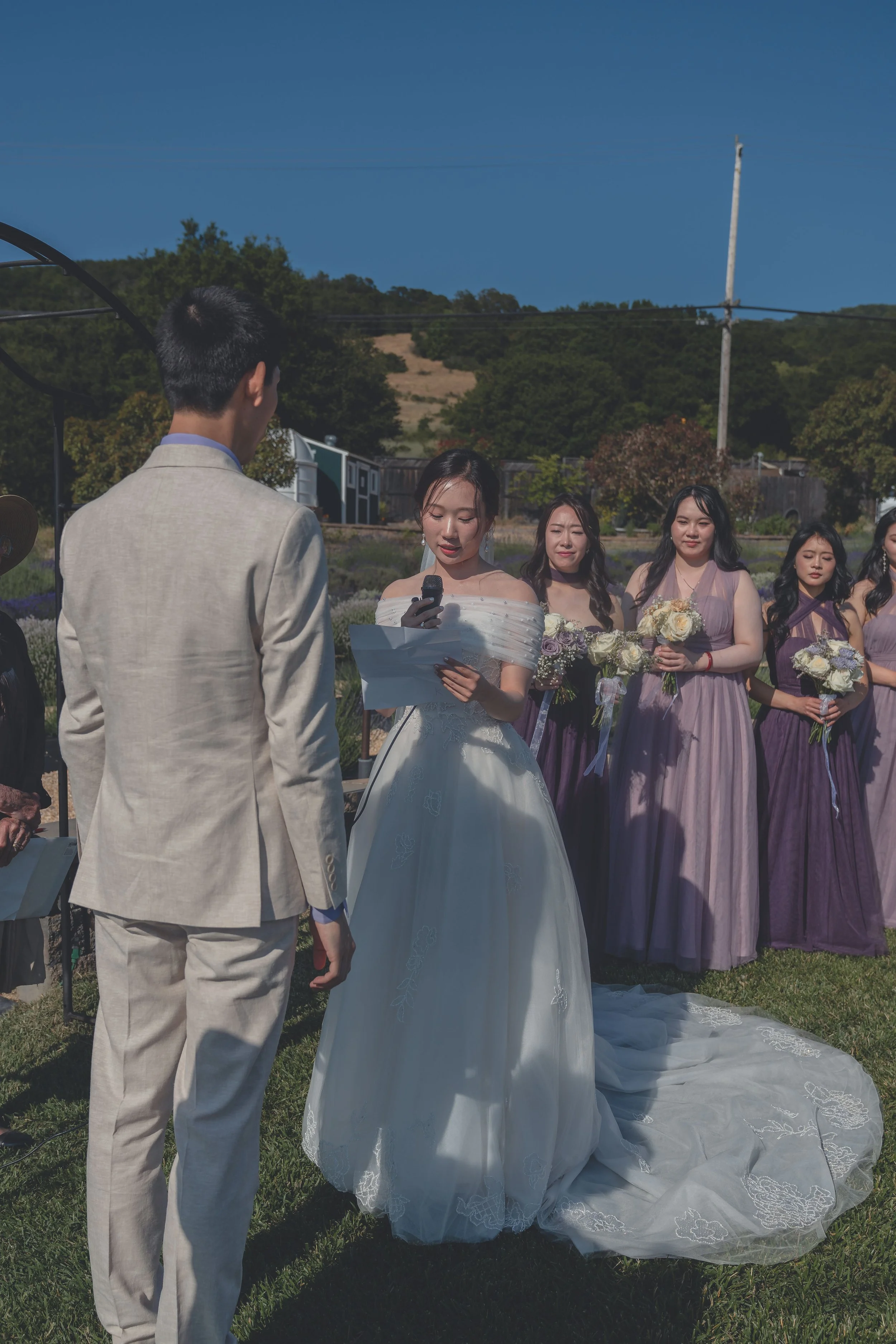 Bride and groom facing one another during the ceremony in California wine country.