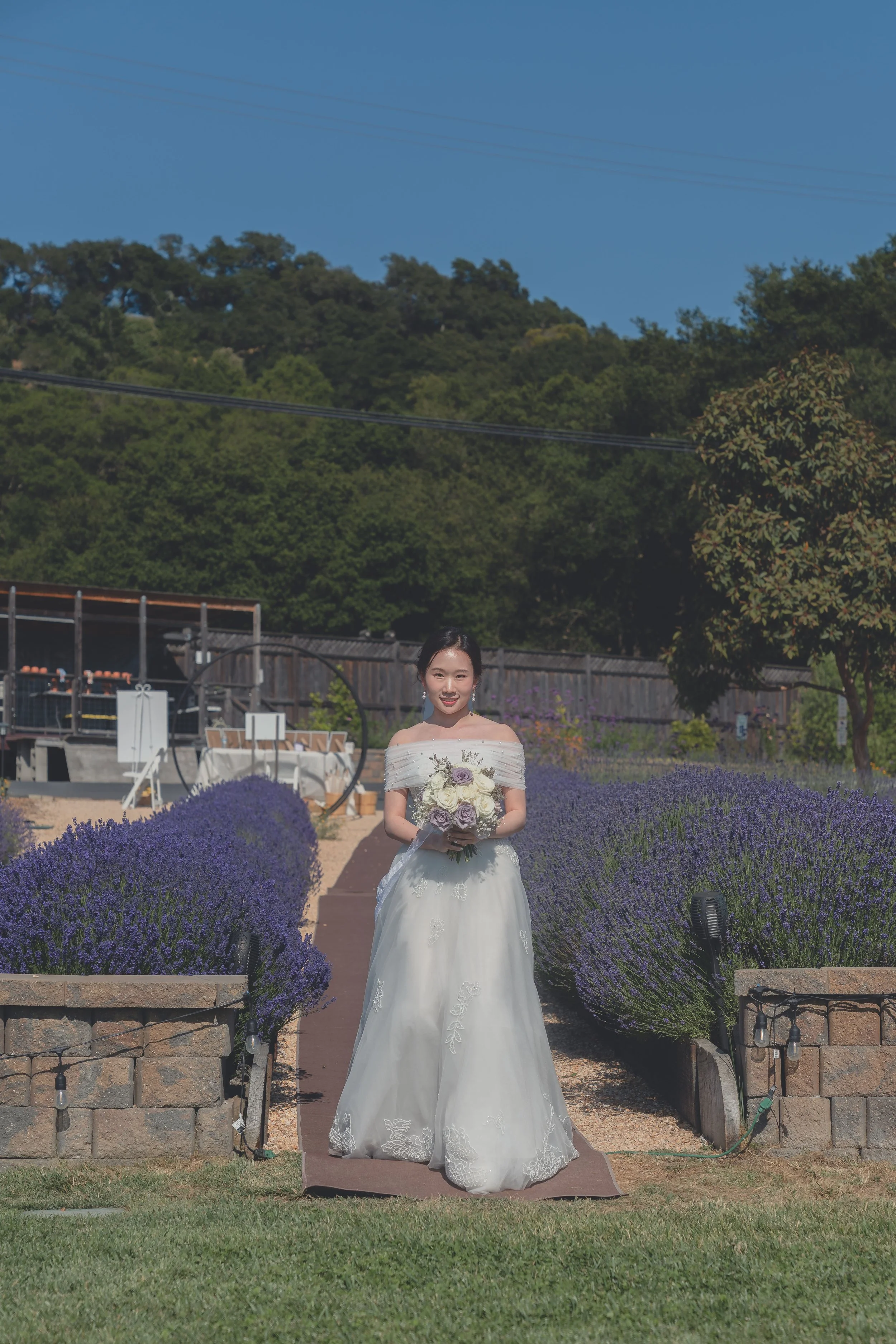 Bride holding her bouquet as she enters the ceremony space in Sonoma.