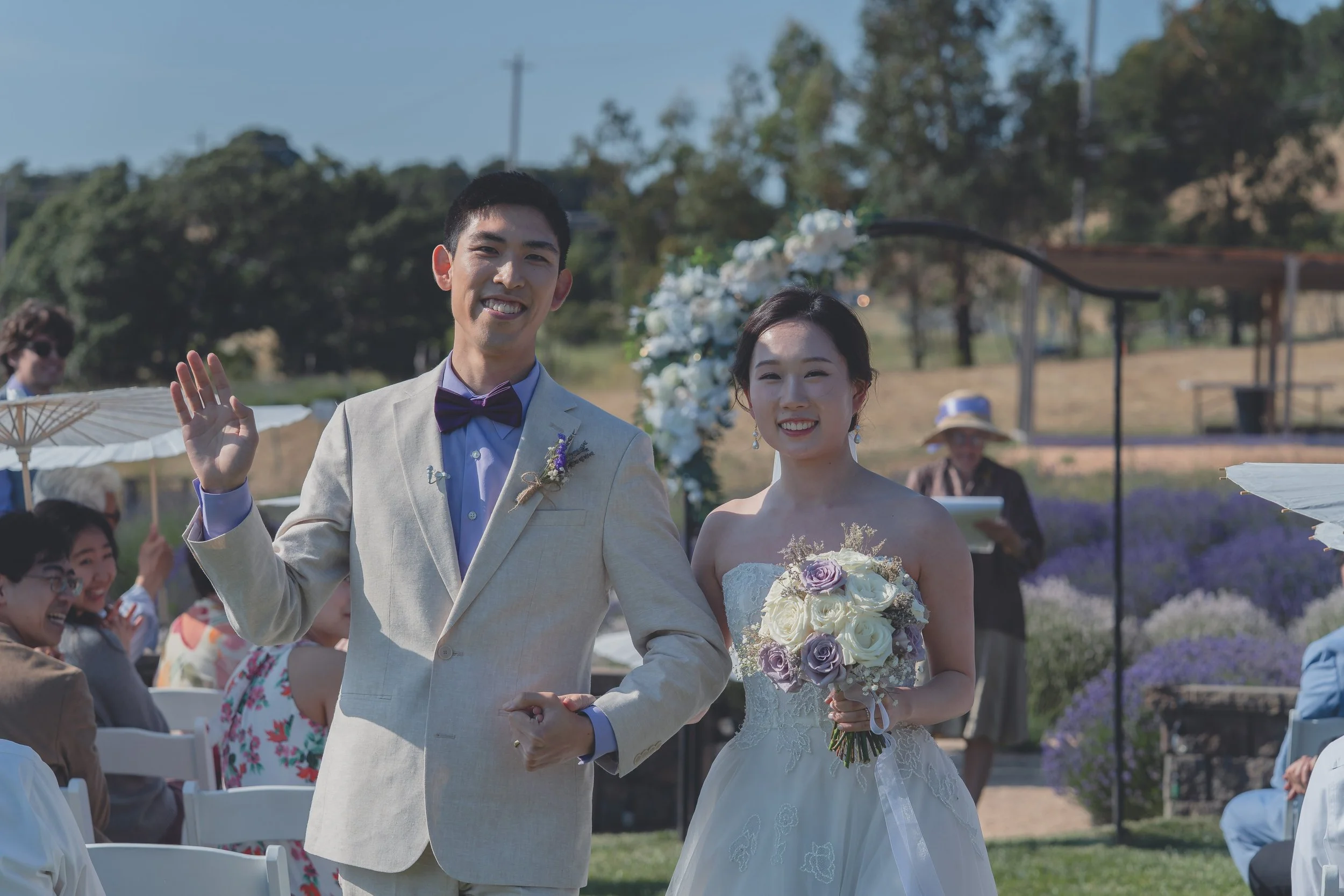 Bride and groom smiling as they walk together during the recessional in Sonoma.