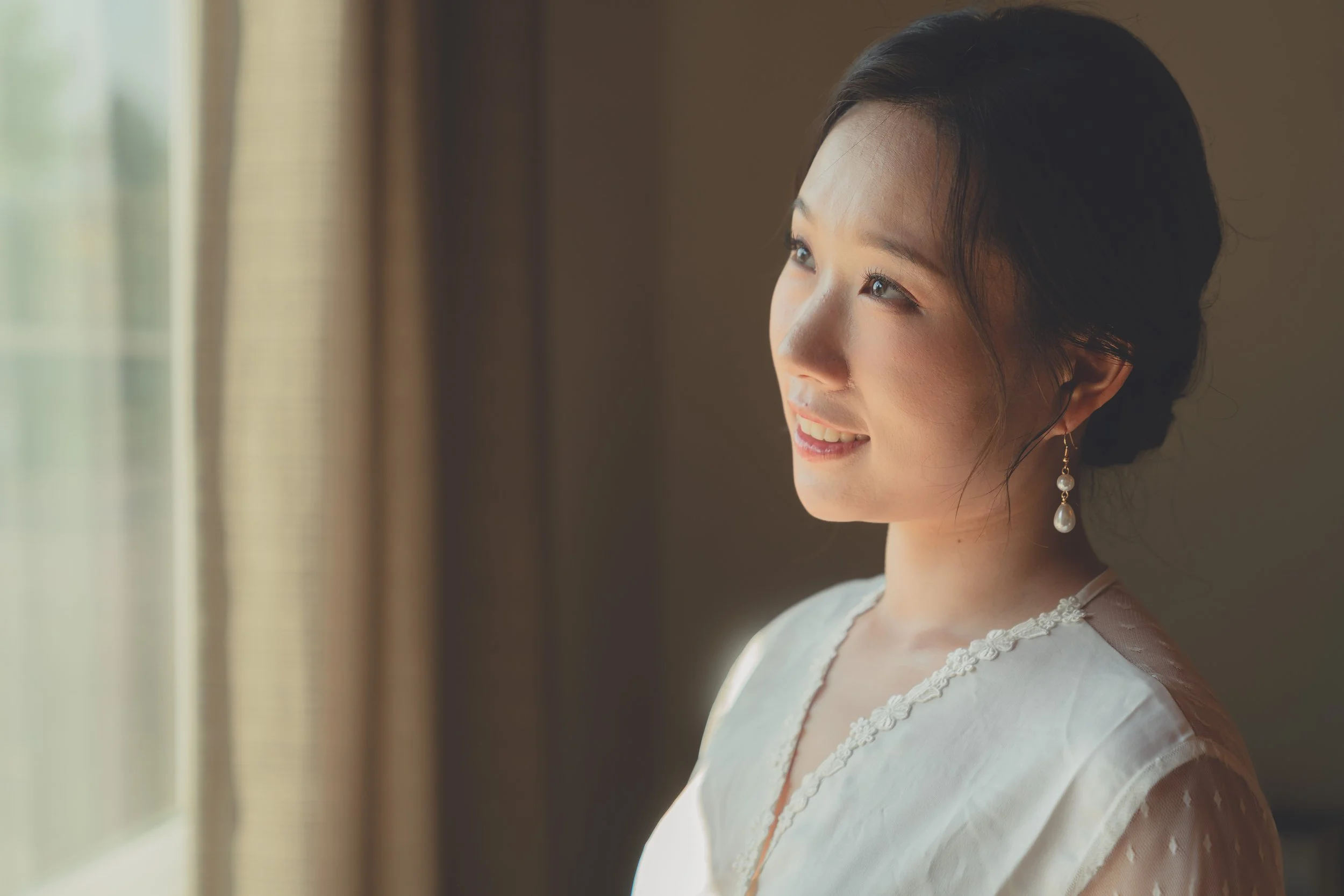 Bride portrait captured in soft window light during a Sonoma wedding.