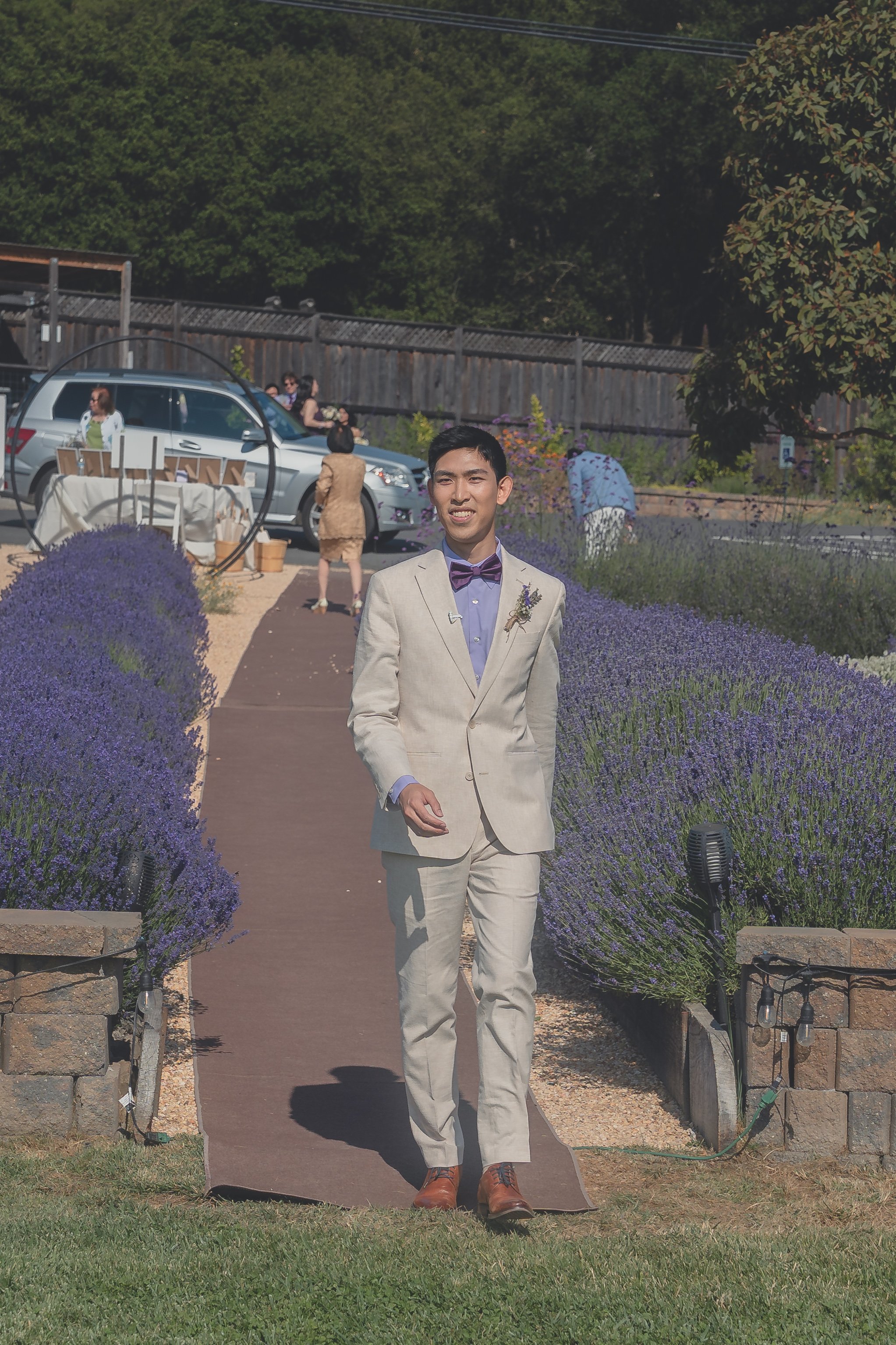 Groom approaching the ceremony space during Katherine and Calvin’s Sonoma wedding.